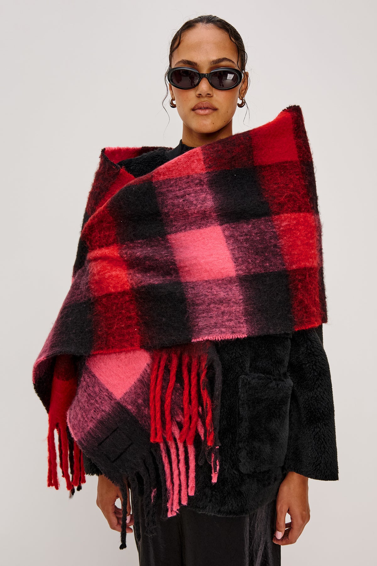 Oslo Scarf with Twisted Tassels and a Checkered Pattern in Charcoal Black Colorway - Front View Featured on Model