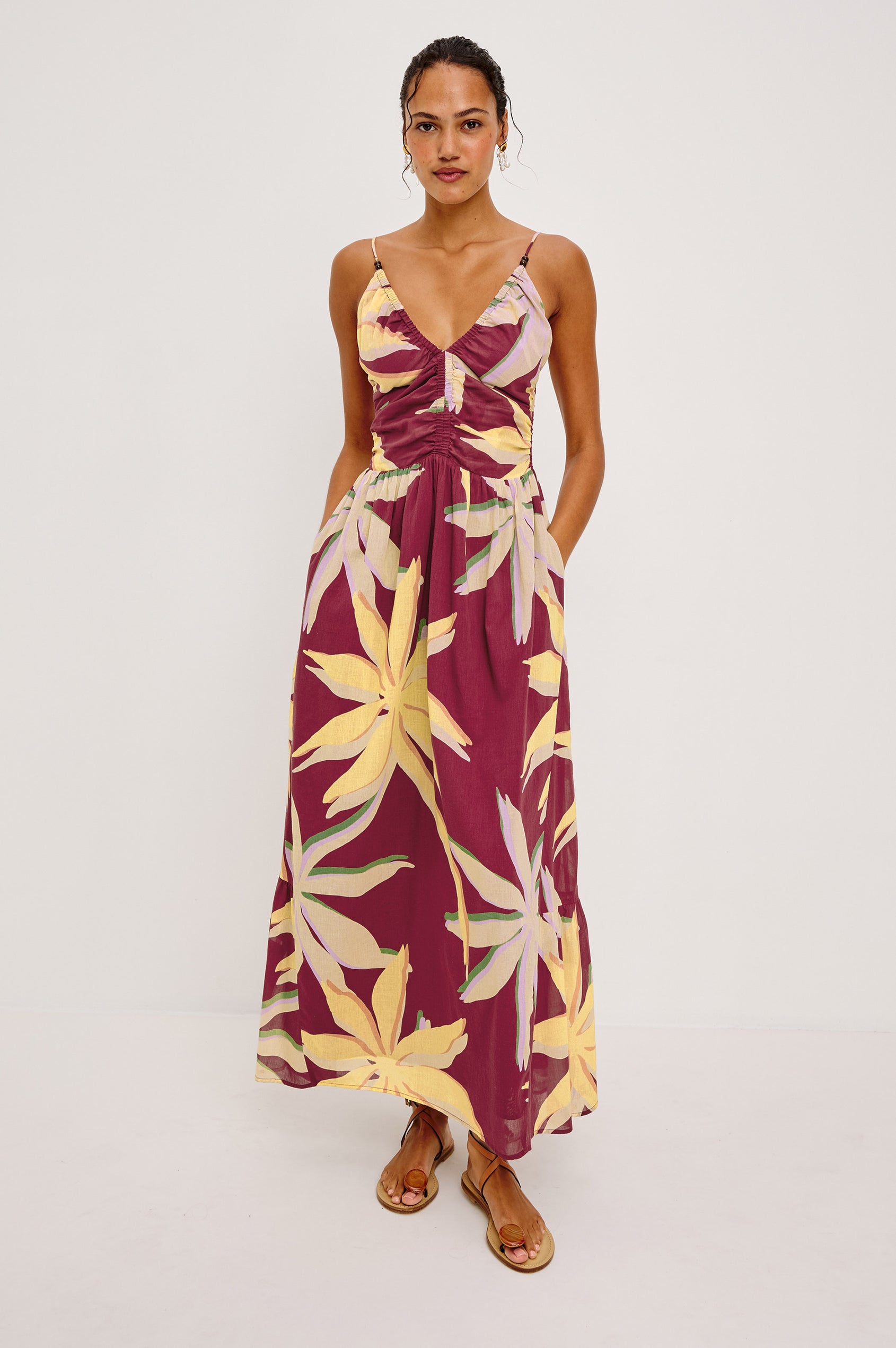 Palm Maxi Dress in Beach Cotton WIth Fitted Shirred Bodice V-Neckline Adjustable Shoulder Straps With Wooden Bead Detailing and Tiered Skirt in Red Palma Colorway - Full Body Front View Featured on Model