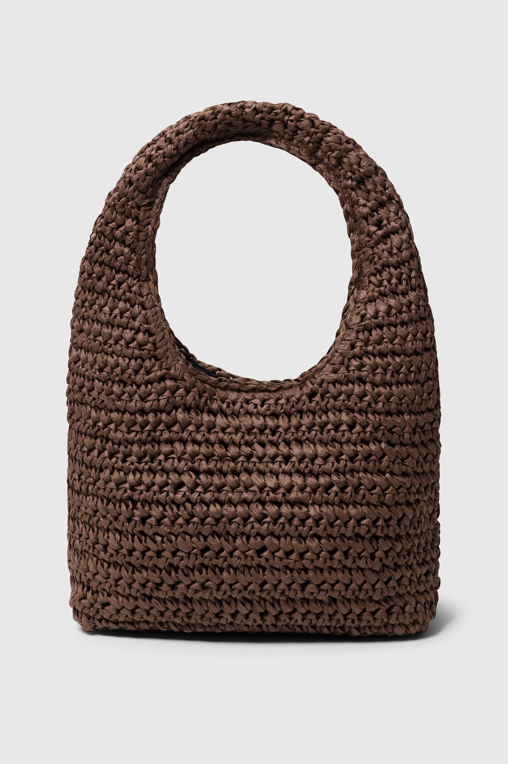 Palma Rattan Shoulder Bag with a Snap Closure and an Interior Pocket in Dark Brown Colorway. Side view of bag.