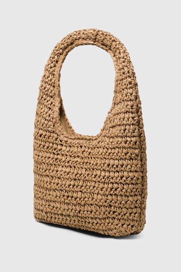 Palma Rattan Shoulder Bag with a Snap Closure and an Interior Pocket in Tan Colorway. Side Angle view of Bag.