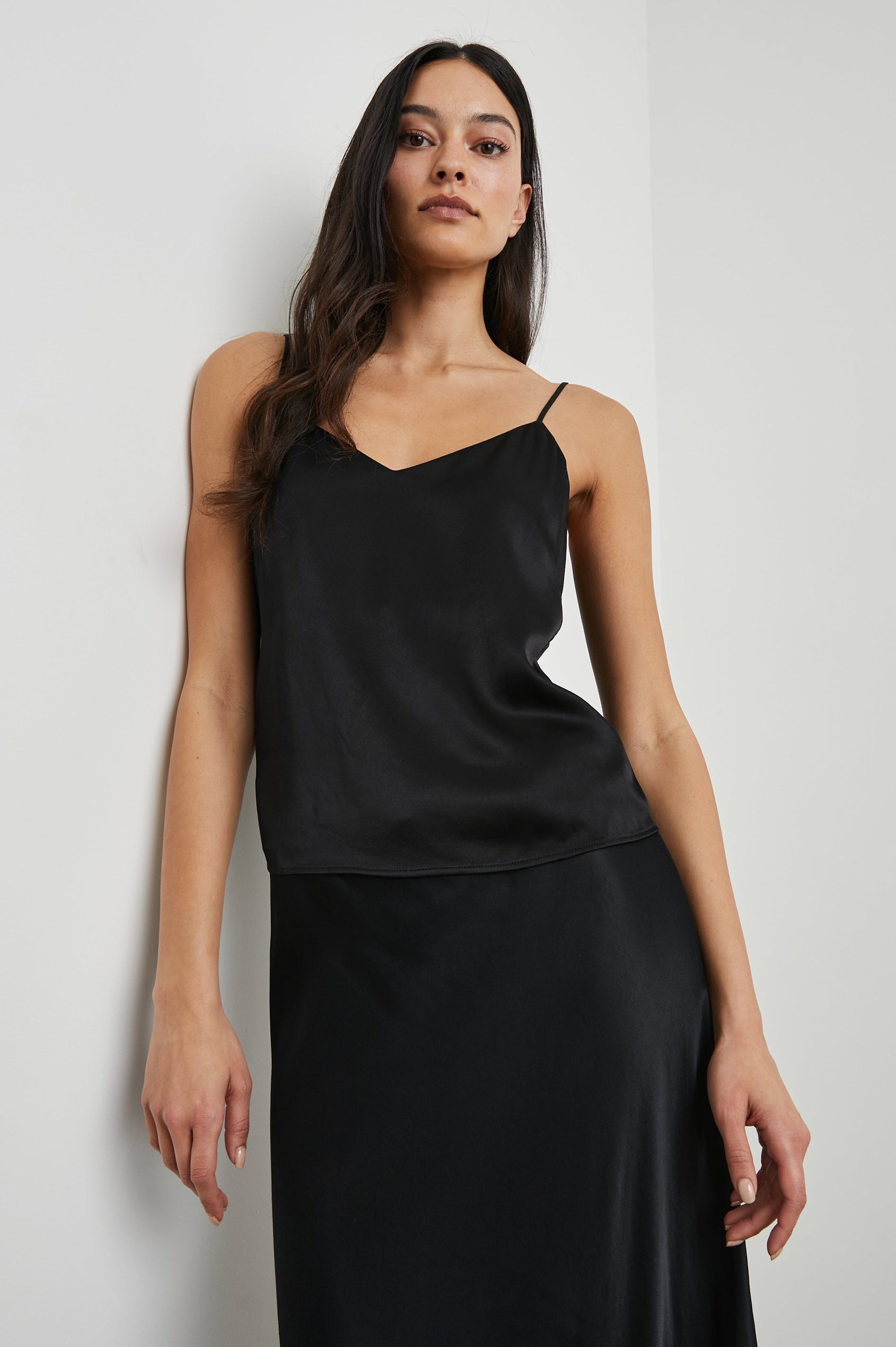 Paola Tank Top with a Deep V Neck and Adjustable Spaghetti Straps in Black Colorway - Front View Featured on Model