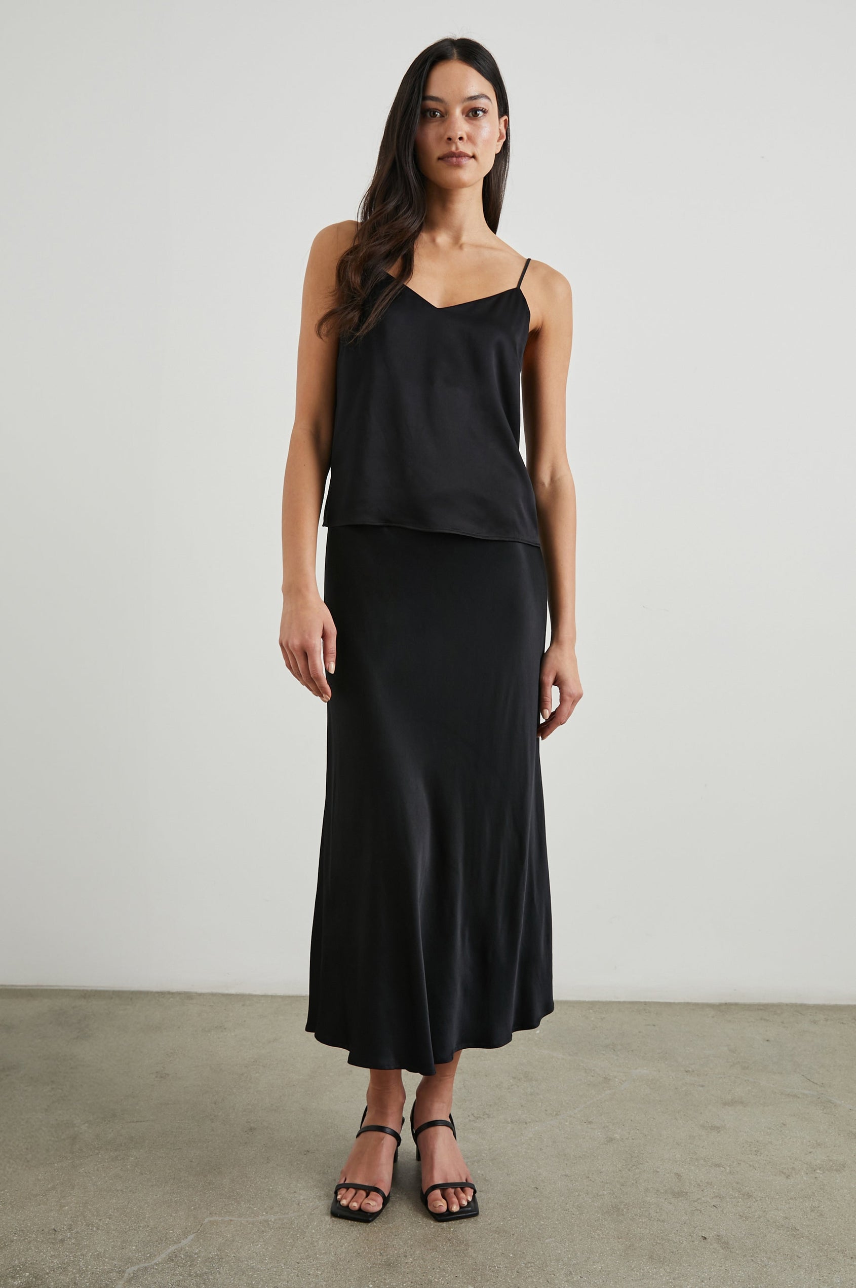 Paola Tank Top with a Deep V Neck and Adjustable Spaghetti Straps in Black Colorway - Front Full Body View Featured on Model