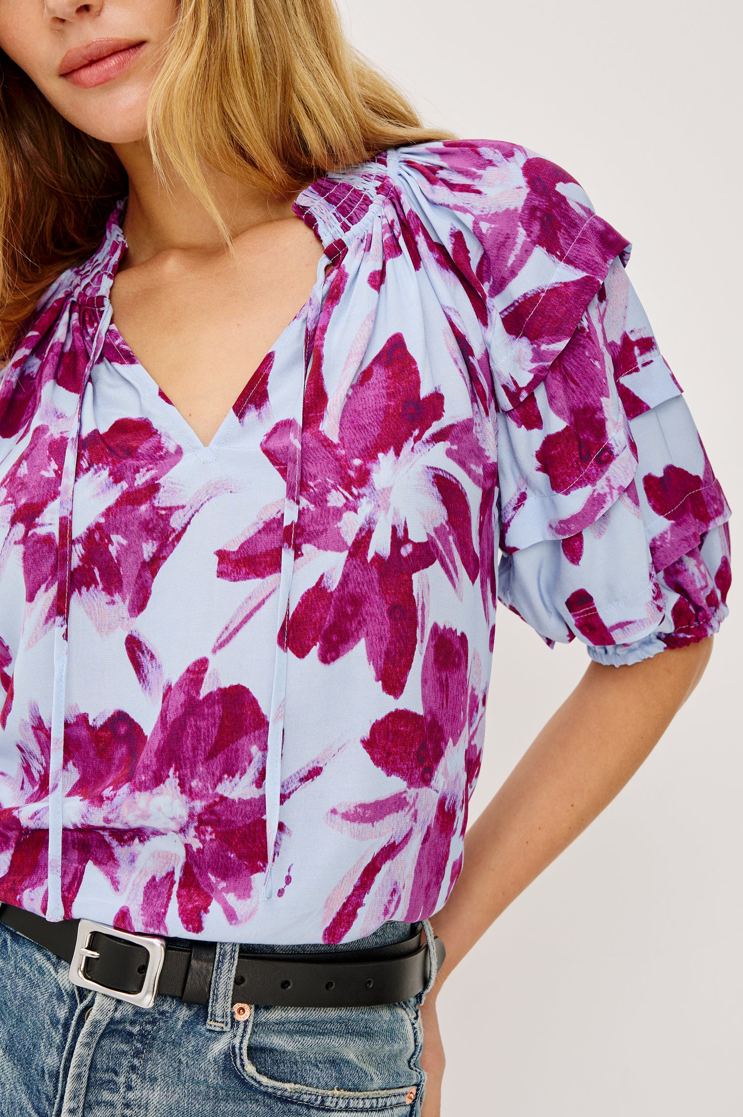 Paris Short-Sleeve Top with Shirred Collar, V-neckline with Ties, Deep Pleats on Sleeves and Elastic at the Sleeve Opening in Blue Lily Colorway, Blues and Pink- Front Tucked View Featured on Model