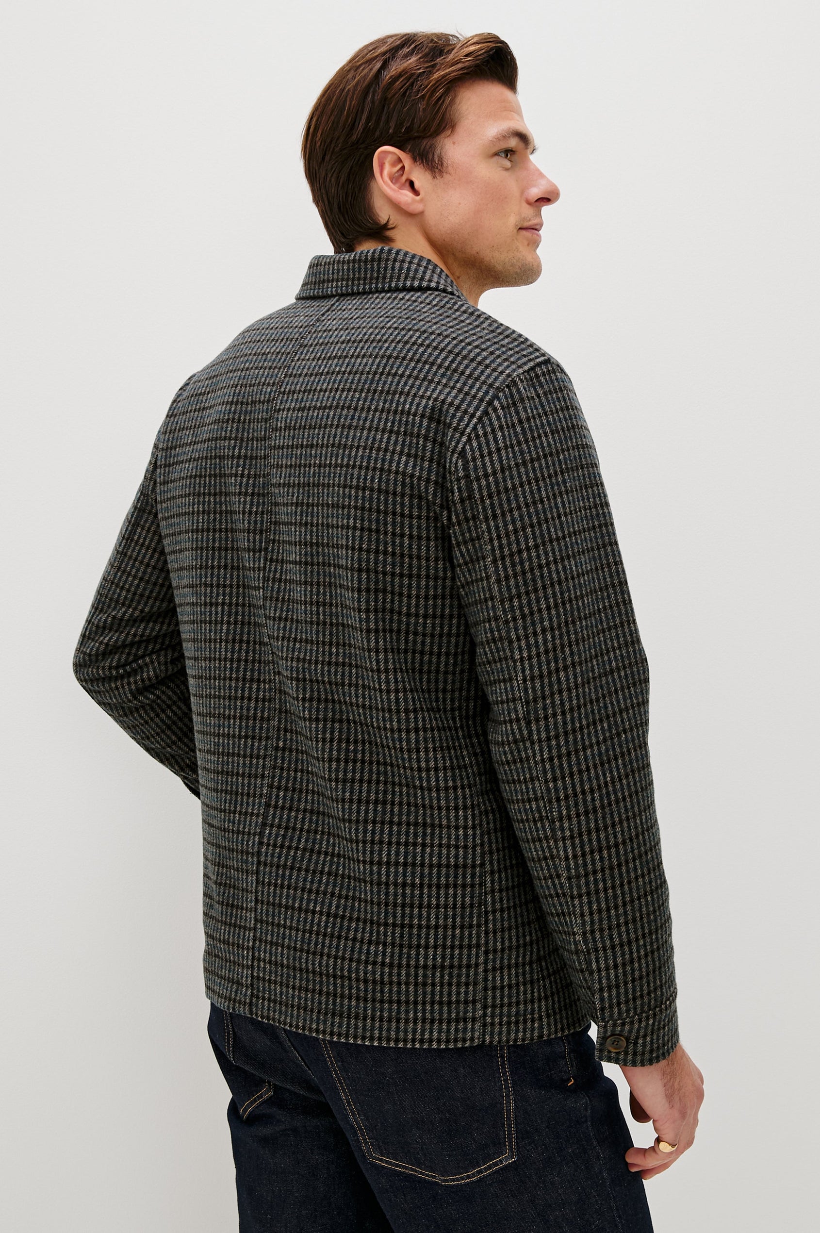The Pascal is a collared button front jacket with front patch pockets and a chest pocket in Grey Check Plaid colorway. Back view featured on model.
