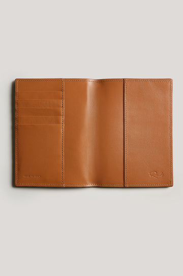 Leather passport holder opened, detailed inside view with, in brown Cognac colorway.