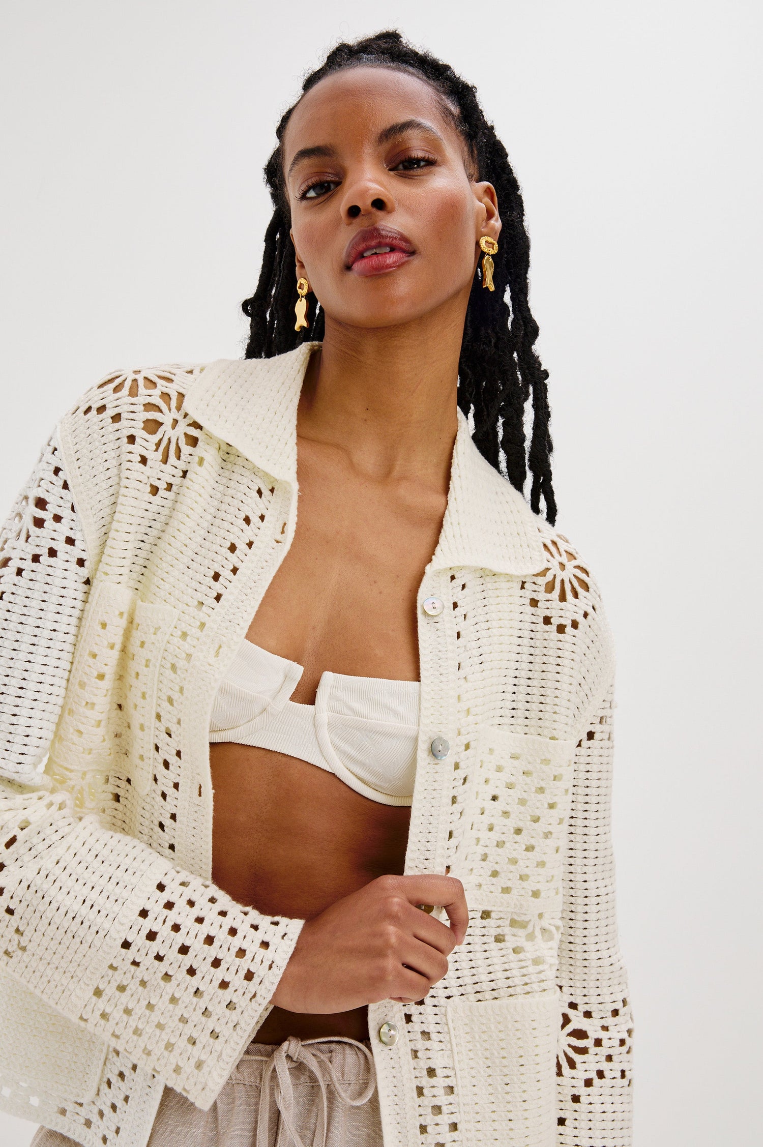 Patmos Collared Button Front Sweater Cardigan with Long Sleeves and Four Front Patch Pockets in Ivory Colorway. Front View Shown on Model.