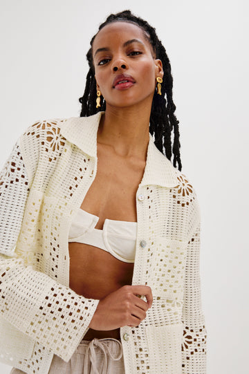 Patmos Collared Button Front Sweater Cardigan with Long Sleeves and Four Front Patch Pockets in Ivory Colorway. Front View Shown on Model.