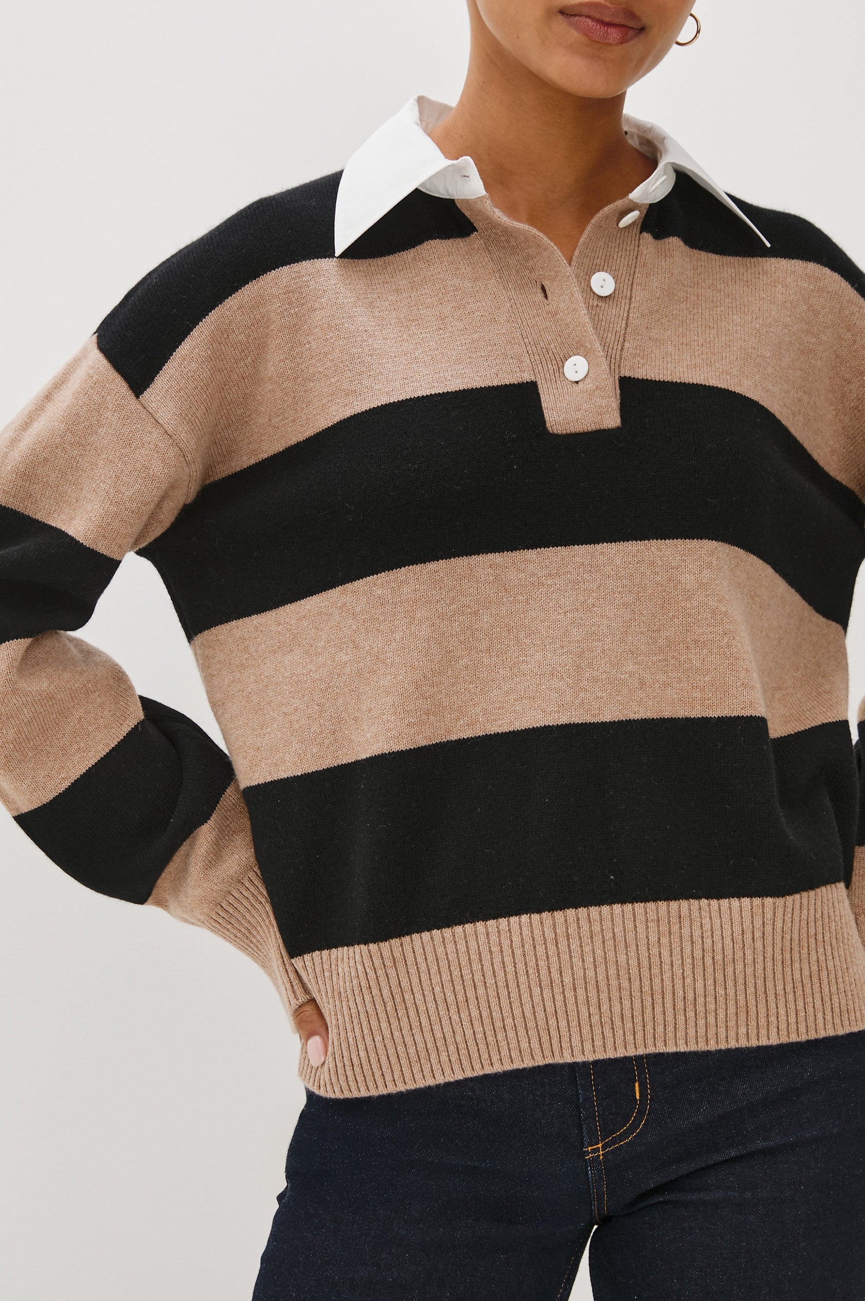 Cotton-cashmere henley sweater with relaxed fit. Design features black heritage-style stripes and a contrasting white cotton poplin collar. Close up view on model.