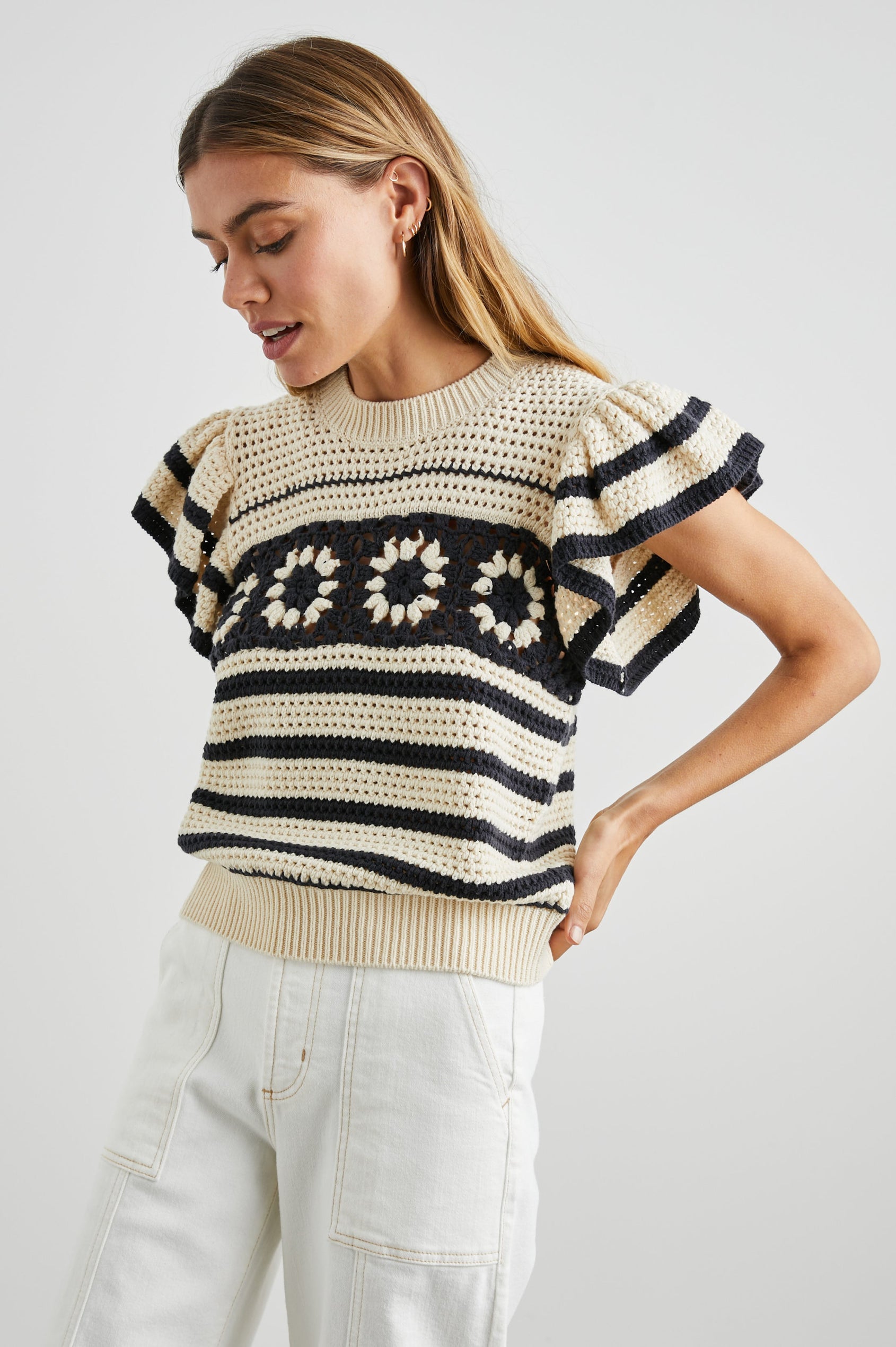 Penelope Crochet Top with Flutter Sleeves and Ribbed Hem in Oat Navy Crochet Colorway, Horizontal Stripes with contrasting knit flowers across the chest - Front View Featured on Model