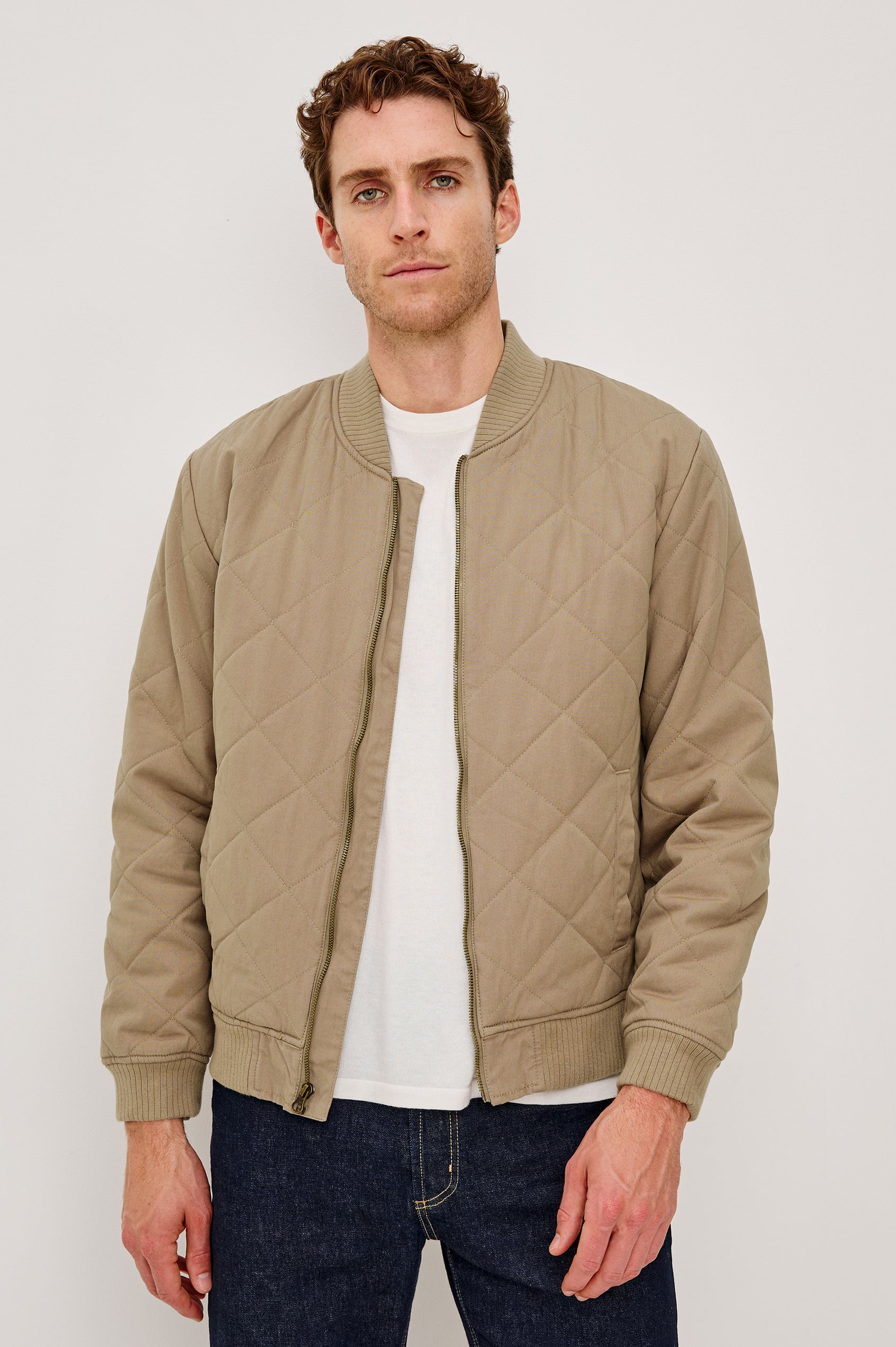 Peninsula Jacket with Zip Closure, Two Front Pockets, an Inner Zippered Pocket, a Quilted Pattern and Ribbed Trim in Vintage Khaki Colorway - Front View Featured on Model