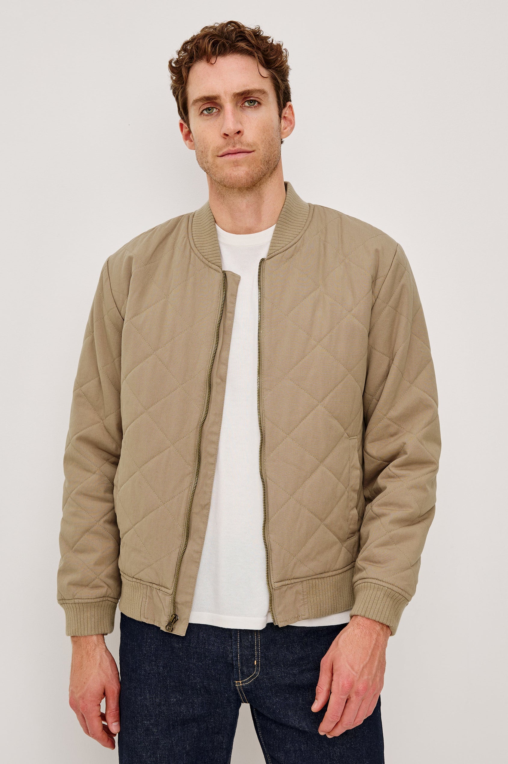 Peninsula Jacket with Zip Closure, Two Front Pockets, an Inner Zippered Pocket, a Quilted Pattern and Ribbed Trim in Vintage Khaki Colorway - Front View Featured on Model