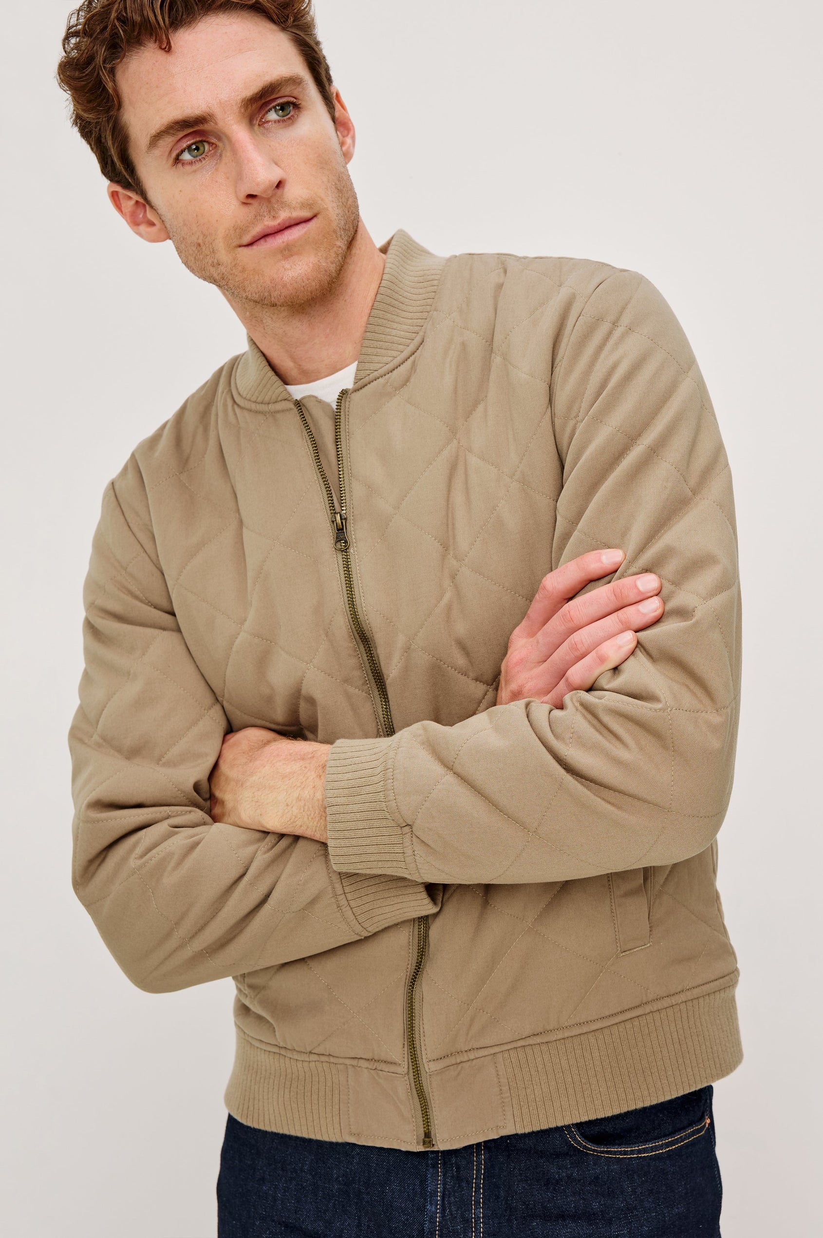 Peninsula Jacket with Zip Closure, Two Front Pockets, an Inner Zippered Pocket, a Quilted Pattern and Ribbed Trim in Vintage Khaki Colorway - Front View Featured on Model