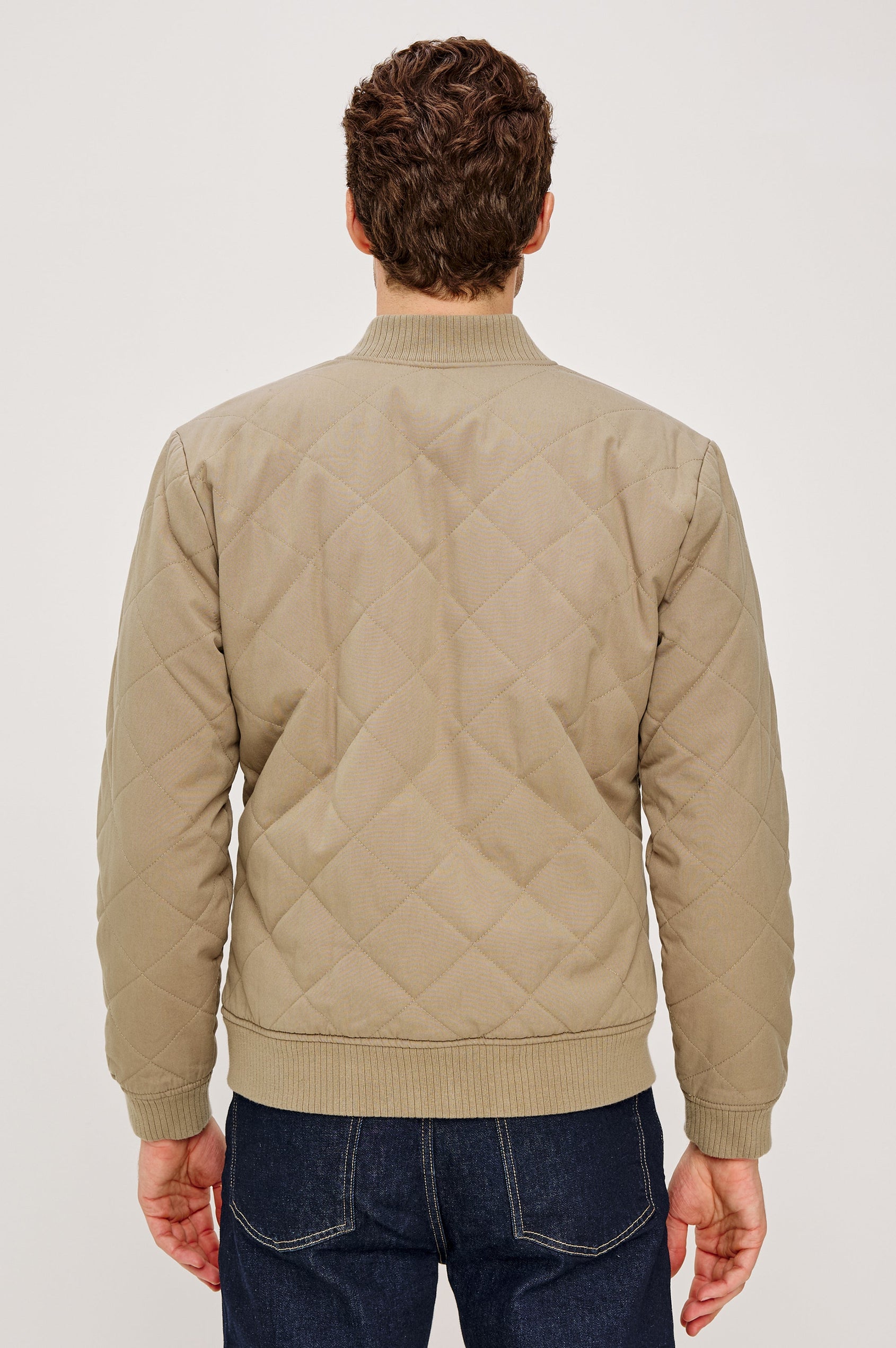 Peninsula Jacket with Zip Closure, Two Front Pockets, an Inner Zippered Pocket, a Quilted Pattern and Ribbed Trim in Vintage Khaki Colorway - Back View Featured on Model