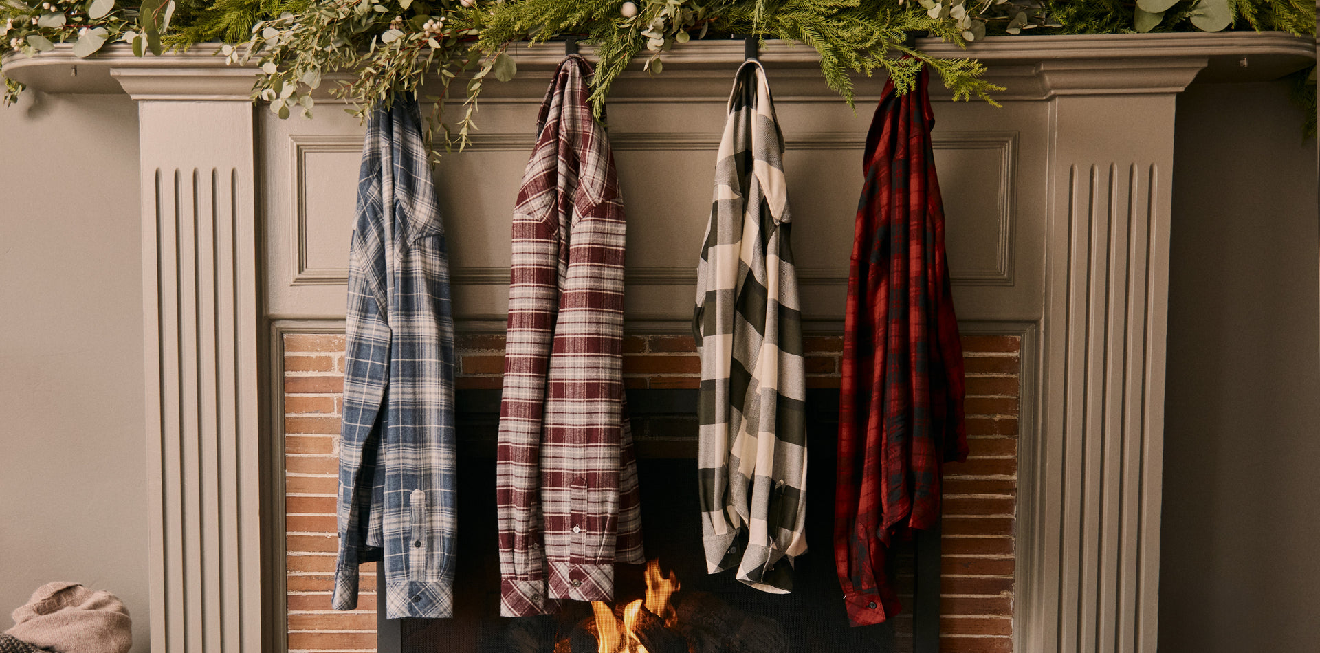 EDITORIAL IMAGE OF MULTIPLE SHIRTS HANGING ON A FIREPLACE