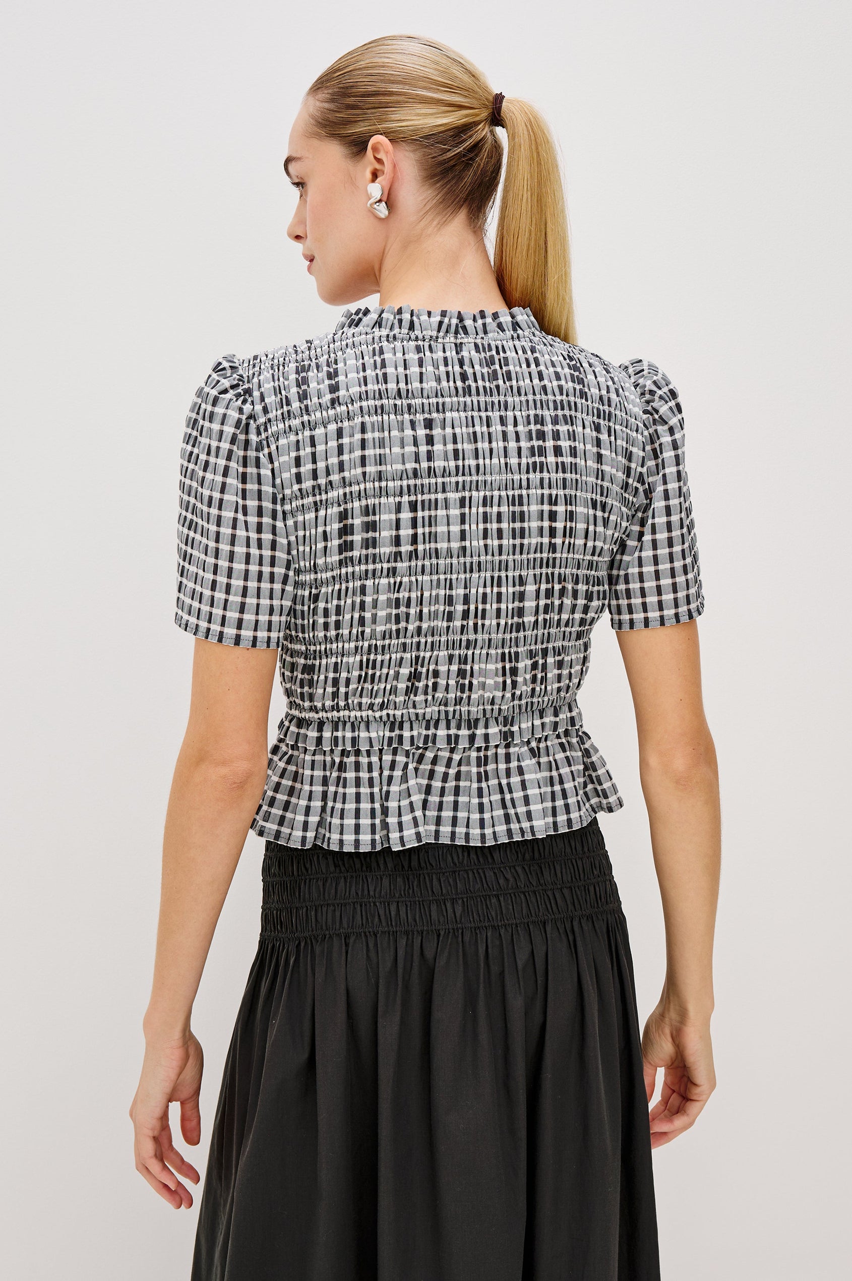 Portia V-Neck Tie Front Top with Short Puff Sleeves and a Ruffled Peplum Hem in Ash Seersucker Colorway. Back View Shown on Model.