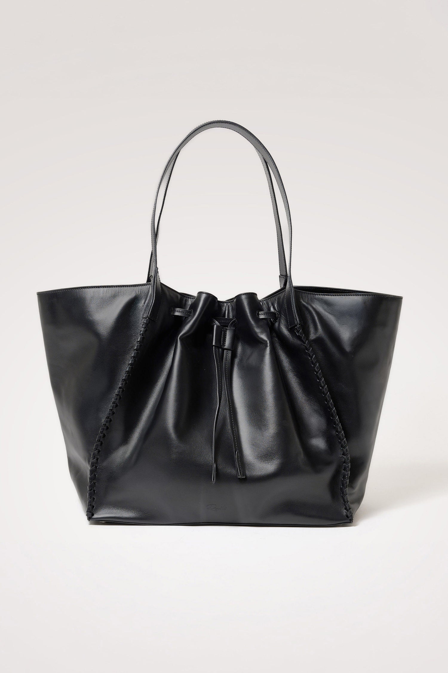 Prato Bucket Tote in Leather With Whipstitch Trim, Fixed Top Straps, Drawcord Closure, Interior Zip Pocket, Interior Slip Pocket in Black Colorway - Front Product View Featured