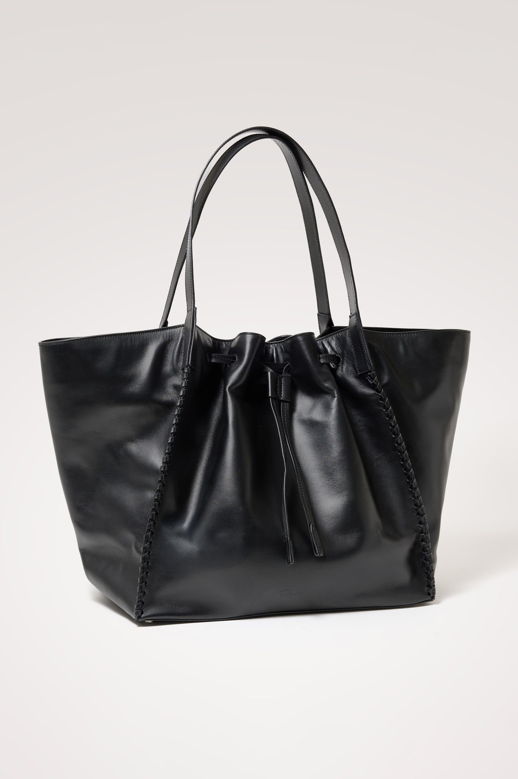 Prato Bucket Tote in Leather With Whipstitch Trim, Fixed Top Straps, Drawcord Closure, Interior Zip Pocket, Interior Slip Pocket in Black Colorway - Front Product View Featured