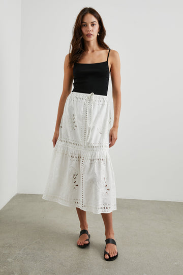 Prina Tiered Midi Skirt with a Drawstring Waist and Floral and Geometric Eyelet Details in White Colorway - Front Full Body View Featured on Model