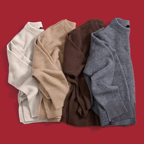 Four folded ribbed knit mock-neck sweaters in cream, beige, brown, and heather gray, arranged side by side on a solid red background.