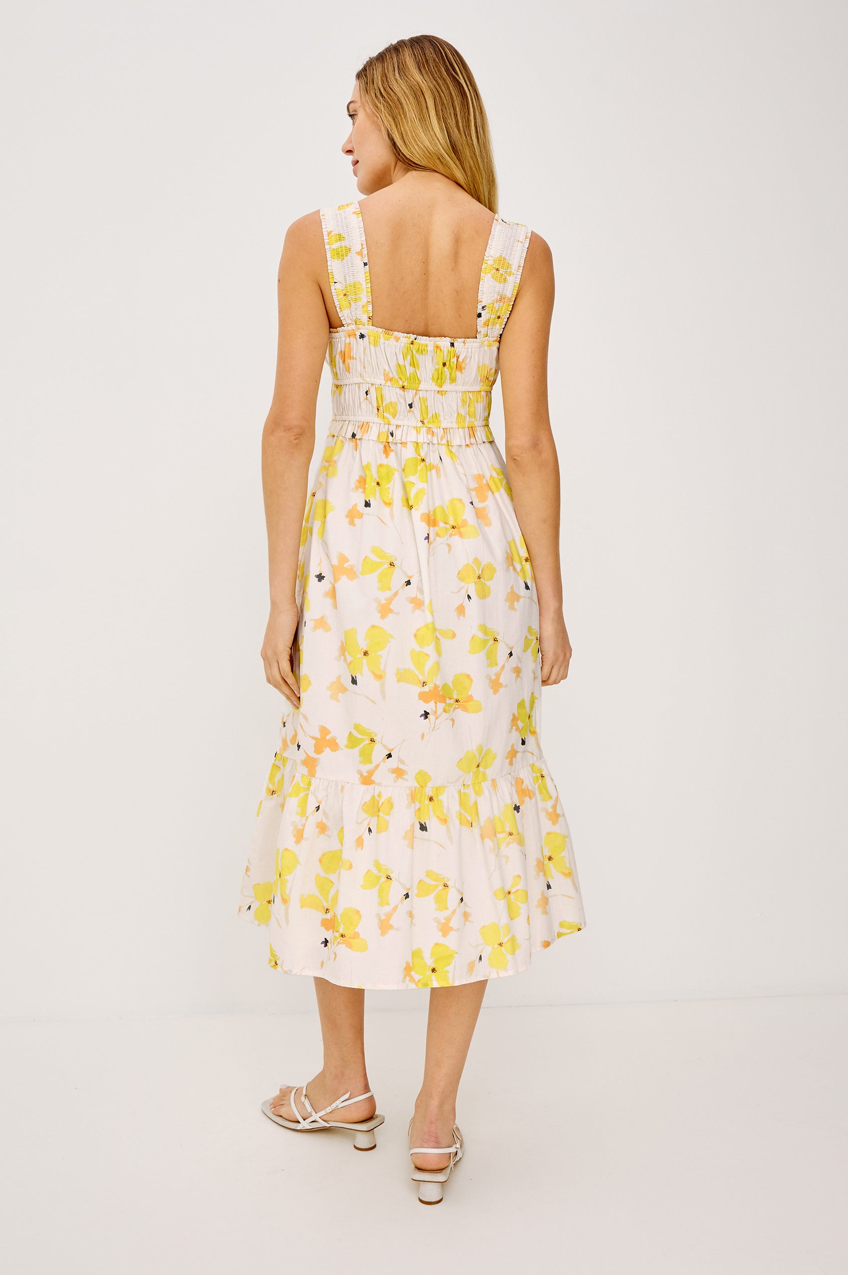 Rafaella Midi Dress in Cotton Poplin With Wide Smocked Shoulder Straps, Gathered Bust, Elasticwated Waist, and Side Pockets in Tossed Daffodils Colorway - Full Body Back View Featured on Model