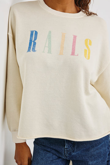 Rails Signature Long-Sleeve Sweatshirt with a Crew Neck, Raw Hem, Shirring Above Cuff, and the Text, Rails, in Ivory Colorway, with Multi Colored Text - Front View Featured on Model 