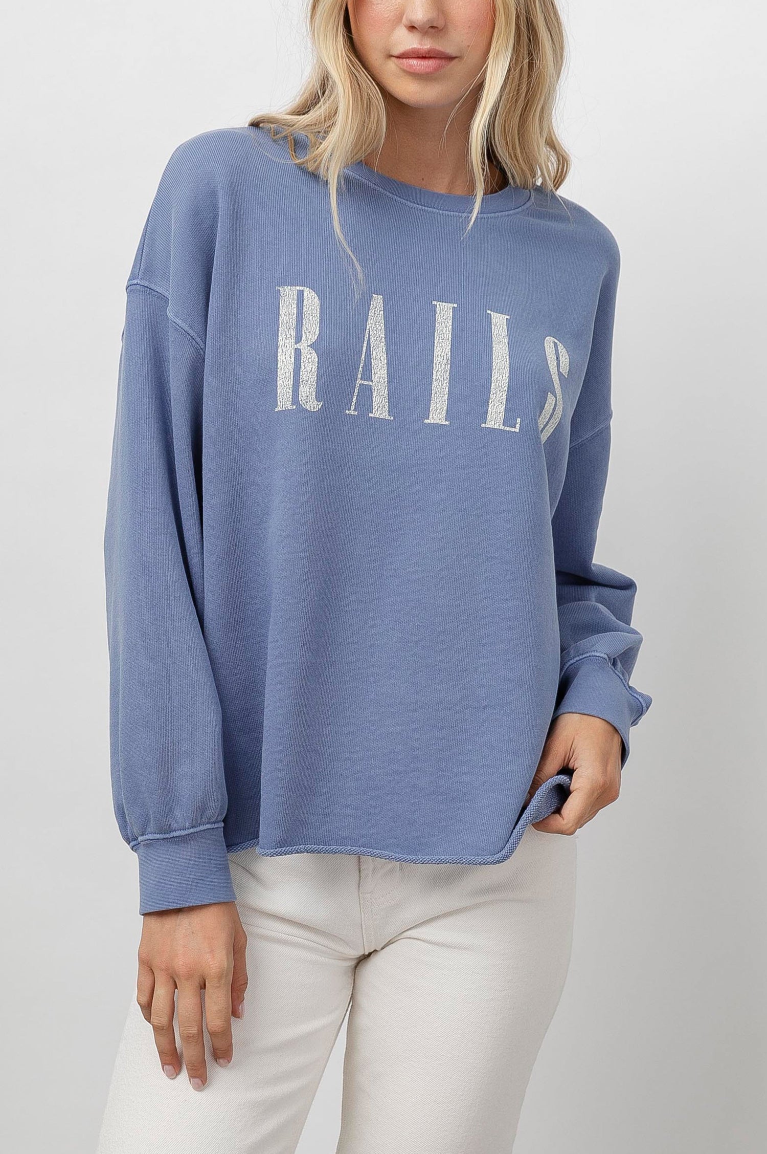 Rails Signature Long-Sleeve Sweatshirt with a Crew Neck, Raw Hem, Shirring Above Cuff, and the Text, Rails, in Washed Indigo Rails Colorway, with Ivory Text - Front View Featured on Model 