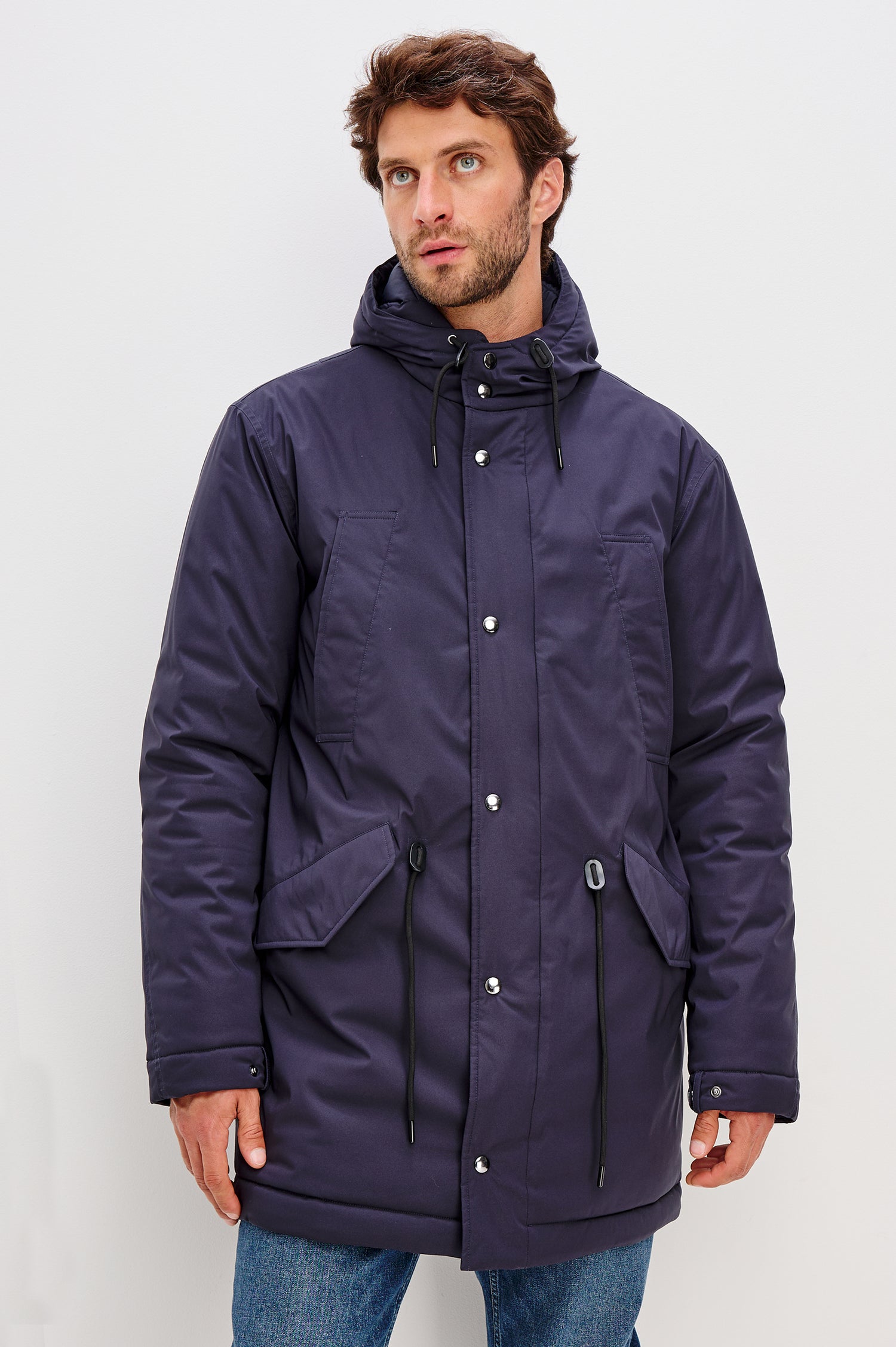 Rainier Parka Coat With Drawcord Hood in Water-Resistant Nylon, Side Snap Button Pockets, Double Front Snap Flap, and Back Seam Vent in Navy Colorway - Full Body Front View Featured on Model