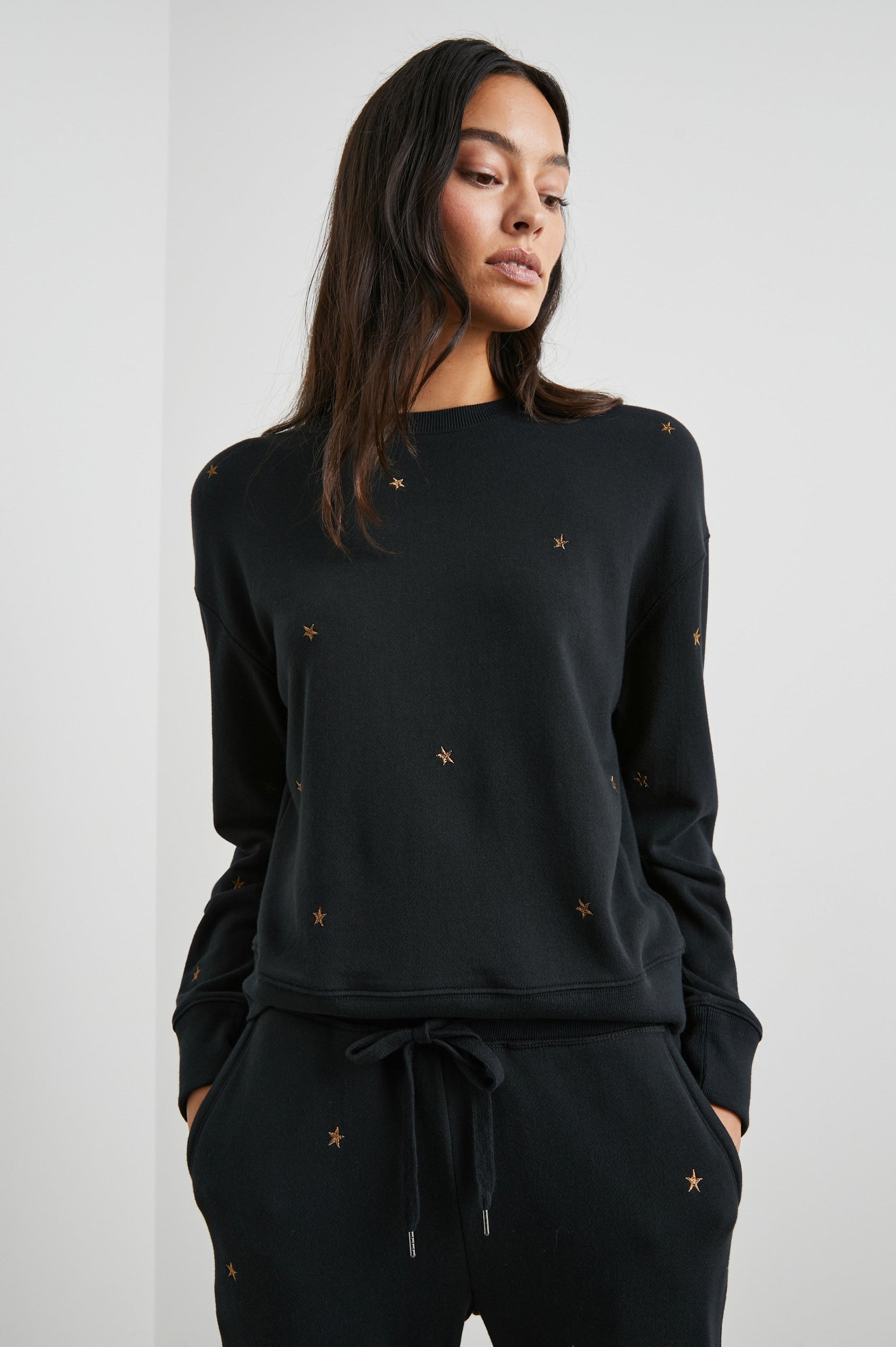 Ramona Long-Sleeve Sweatshirt with a Crew Neck in Bronze Star Embroidery Colorway, Bronze Stars on Black - Front View Featured on Model
