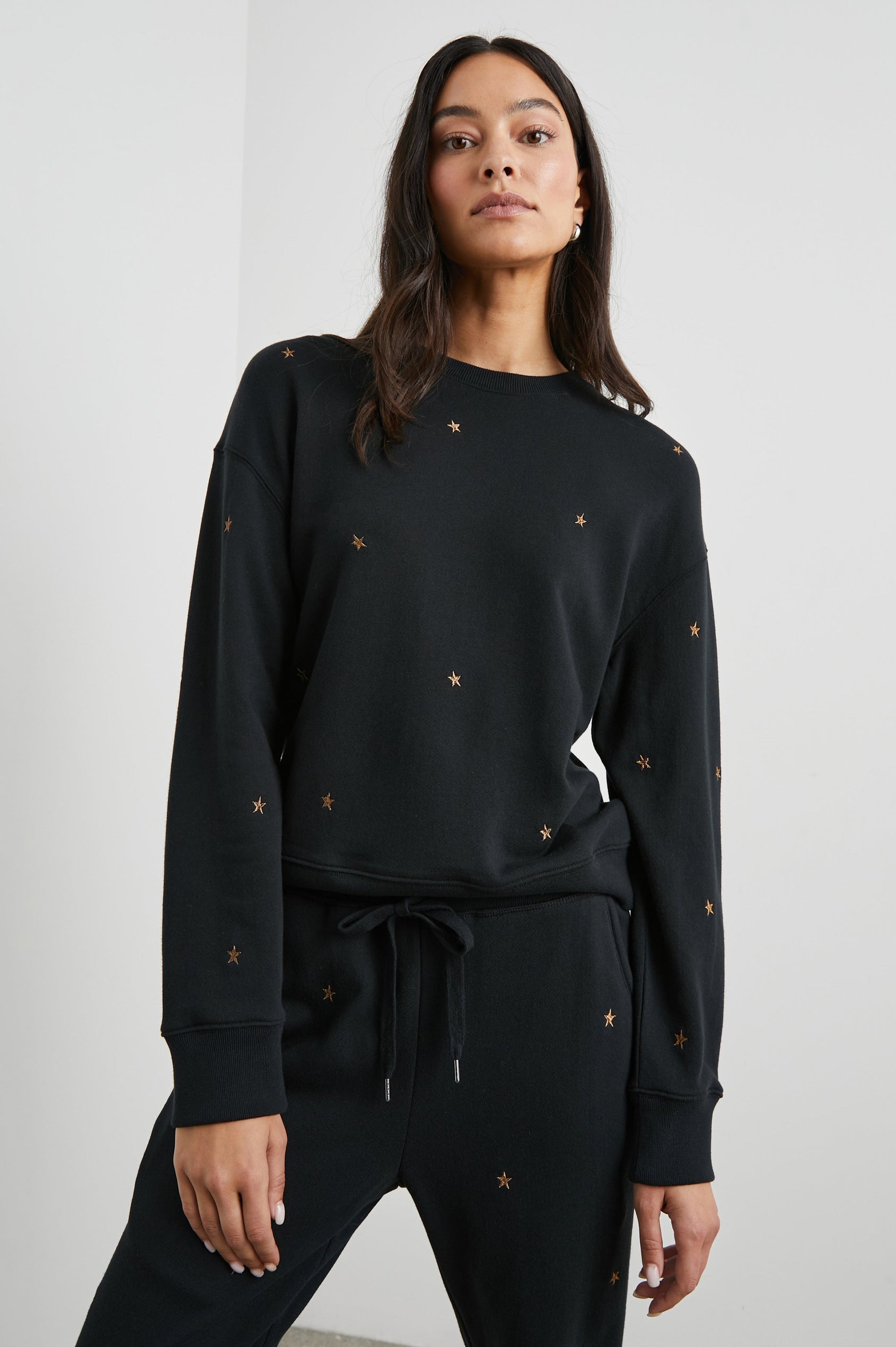 Ramona Long-Sleeve Sweatshirt with a Crew Neck in Bronze Star Embroidery Colorway, Bronze Stars on Black - Front View Featured on Model