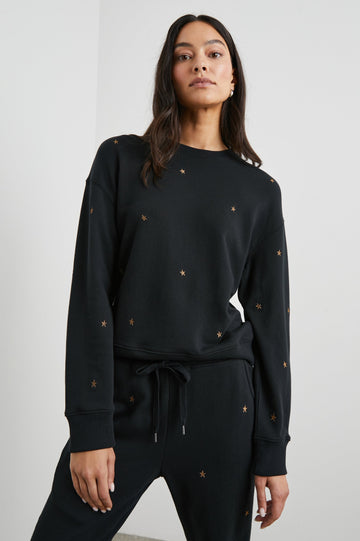 Ramona Long-Sleeve Sweatshirt with a Crew Neck in Bronze Star Embroidery Colorway, Bronze Stars on Black - Front View Featured on Model