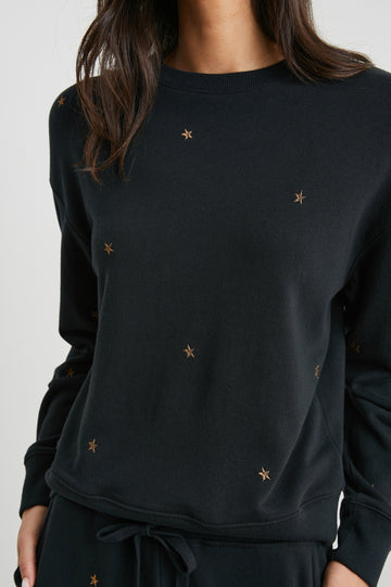 Ramona Long-Sleeve Sweatshirt with a Crew Neck in Bronze Star Embroidery Colorway, Bronze Stars on Black - Front View Featured on Model
