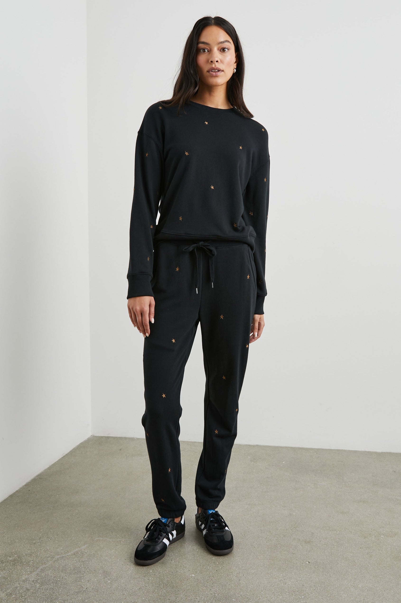 Ramona Long-Sleeve Sweatshirt with a Crew Neck in Bronze Star Embroidery Colorway, Bronze Stars on Black - Front Full Body View Featured on Model