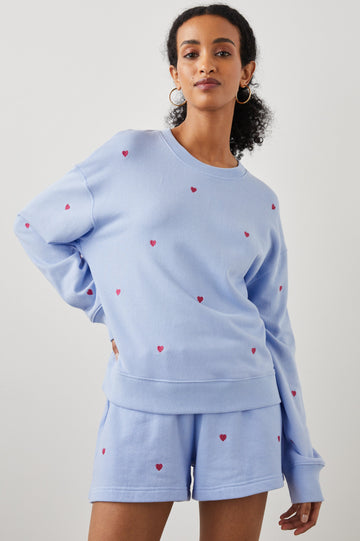 Ramona Long-Sleeve Sweatshirt with a Crew Neck in Pink Heart Embroidery Colorway, Pink Hearts on Blue - Front View Featured on Model