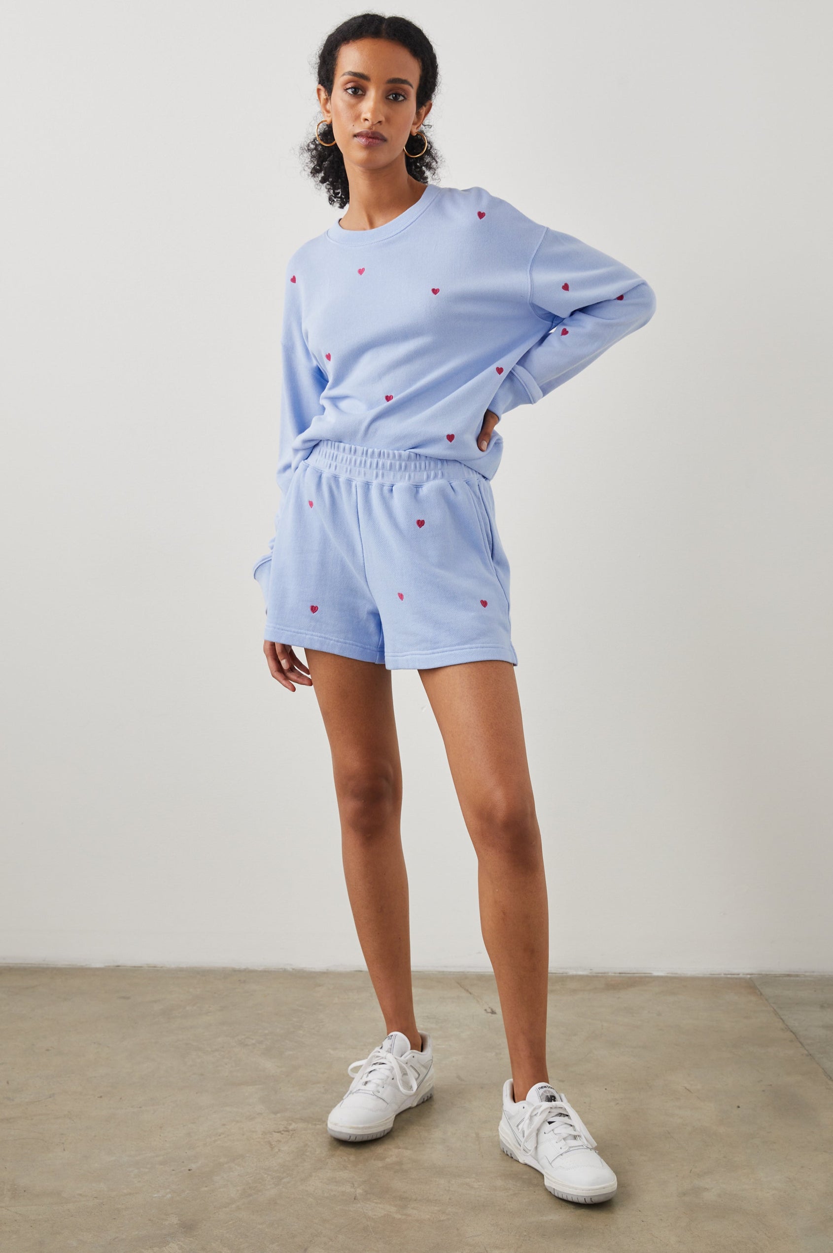 Ramona Long-Sleeve Sweatshirt with a Crew Neck in Pink Heart Embroidery Colorway, Pink Hearts on Blue - Front Full Body View Featured on Model