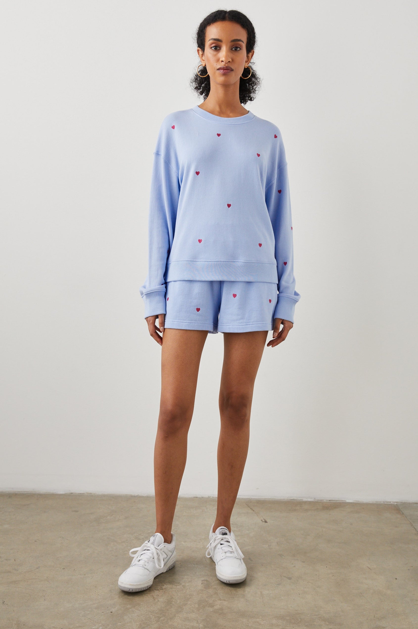 Ramona Long-Sleeve Sweatshirt with a Crew Neck in Pink Heart Embroidery Colorway, Pink Hearts on Blue - Front Full Body View Featured on Model