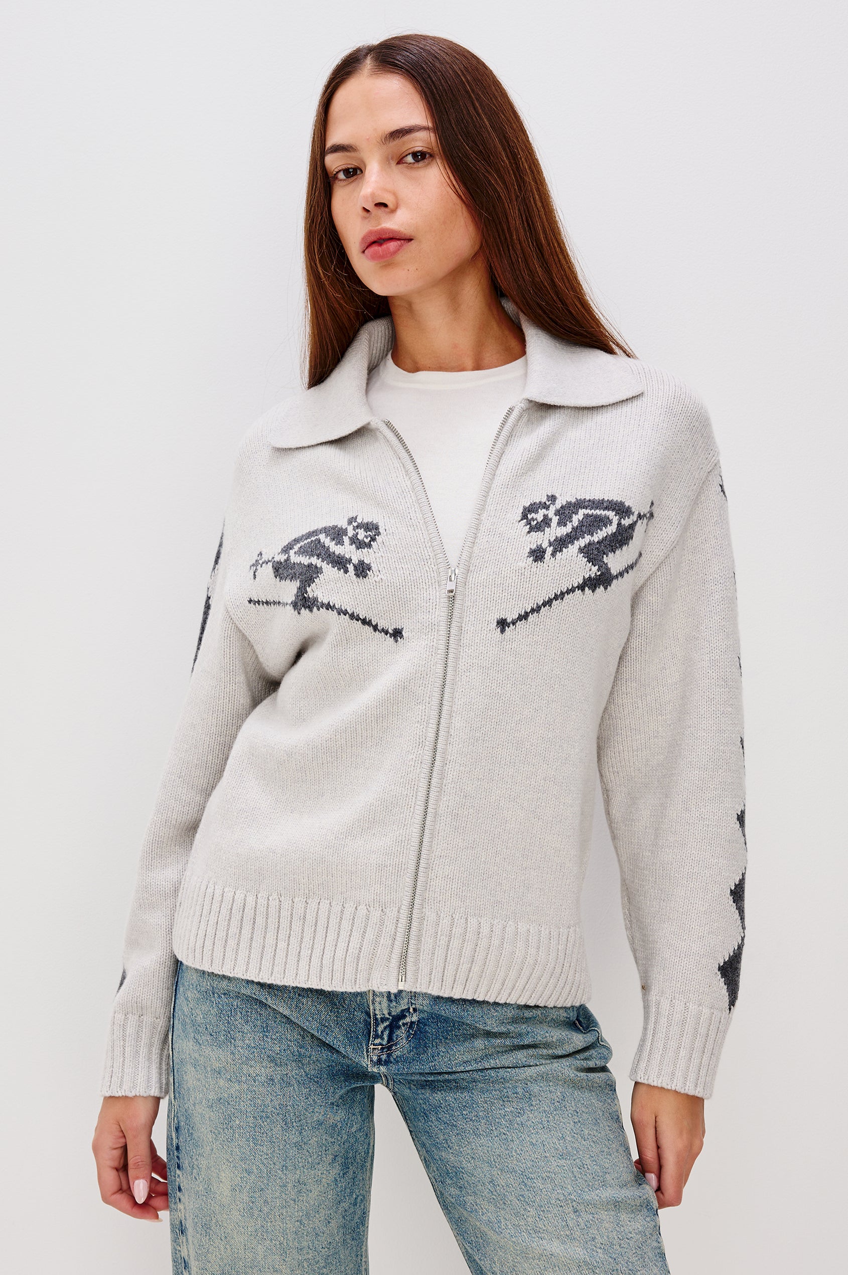 Rhea Longline Cardigan in Wool Blend With Skier Motifs, Stand Collar, Diamond Detailing at Long Sleeves, Relaxed Fit, and Front Zipper in Powder Grey Colorway - Upper Body Front View Featured on Model