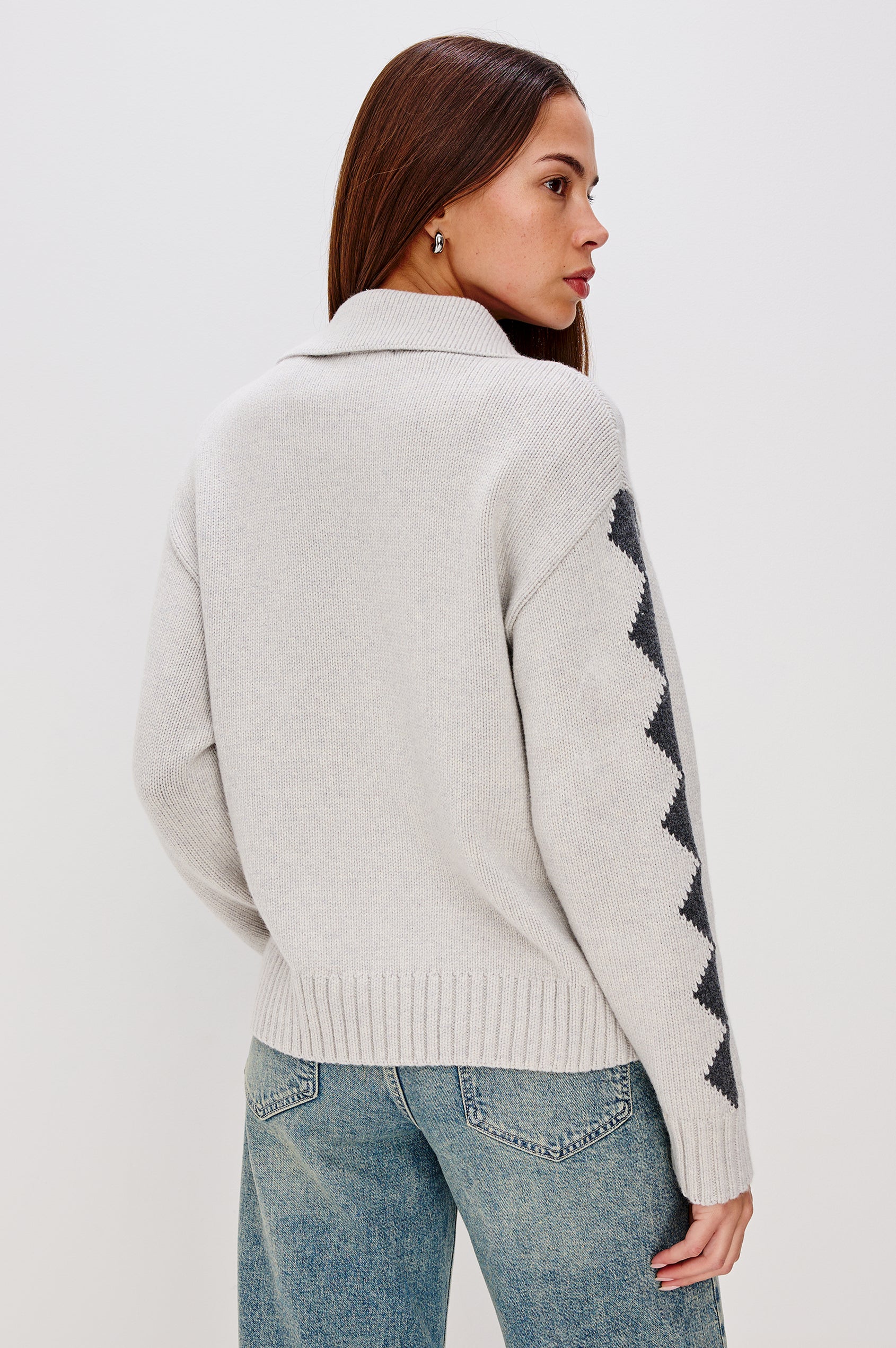Rhea, a longline cardigan in a wool blend with skier motifs in Powder Grey Colorway. The cardigan has a relaxed fit and zip-front closure. Back View Featured on Model