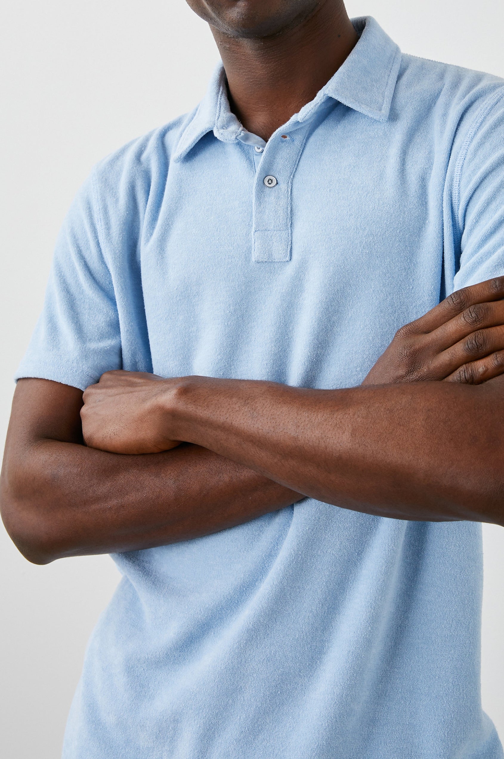 Rhen Short-Sleeve Polo Shirt with a Three-Button Placket in Terry Chambray Blue Colorway - Front View Featured on Model
