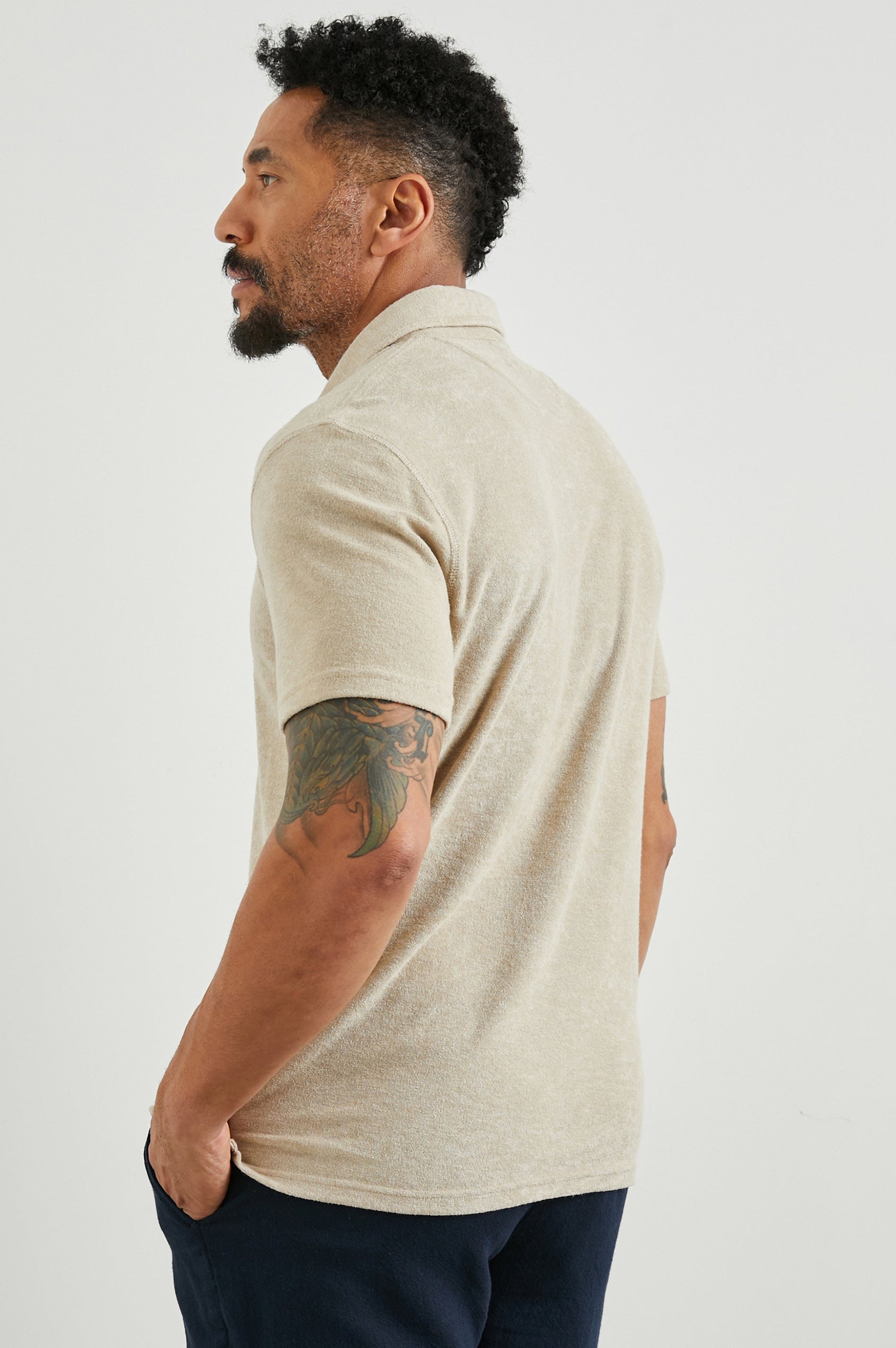 Rhen Short-Sleeve Polo Shirt with a Three-Button Placket in Chickpea Colorway - Back View Featured on Model