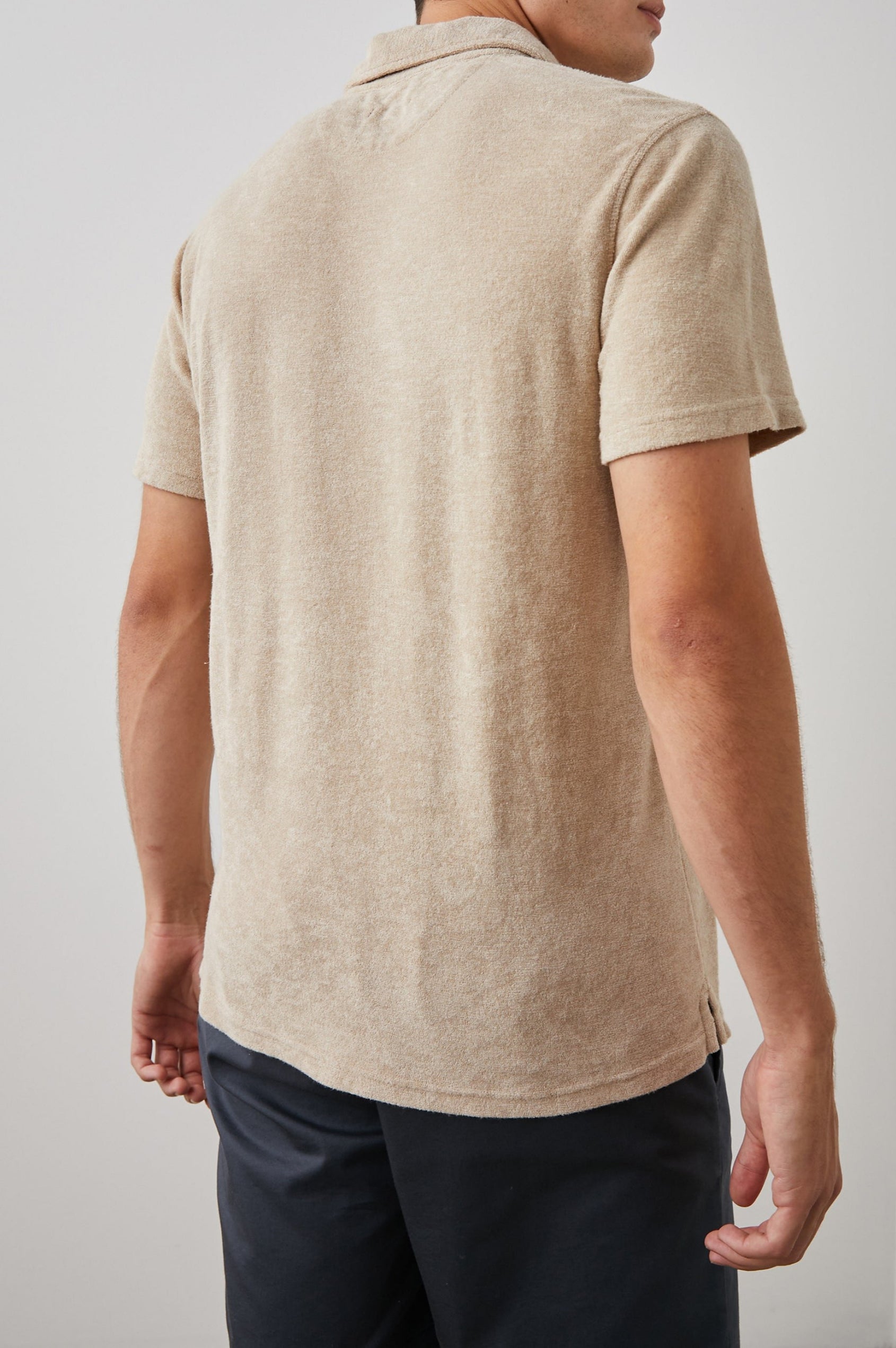 Rhen Short-Sleeve Polo Shirt with a Three-Button Placket in Chickpea Colorway - Back View Featured on Model
