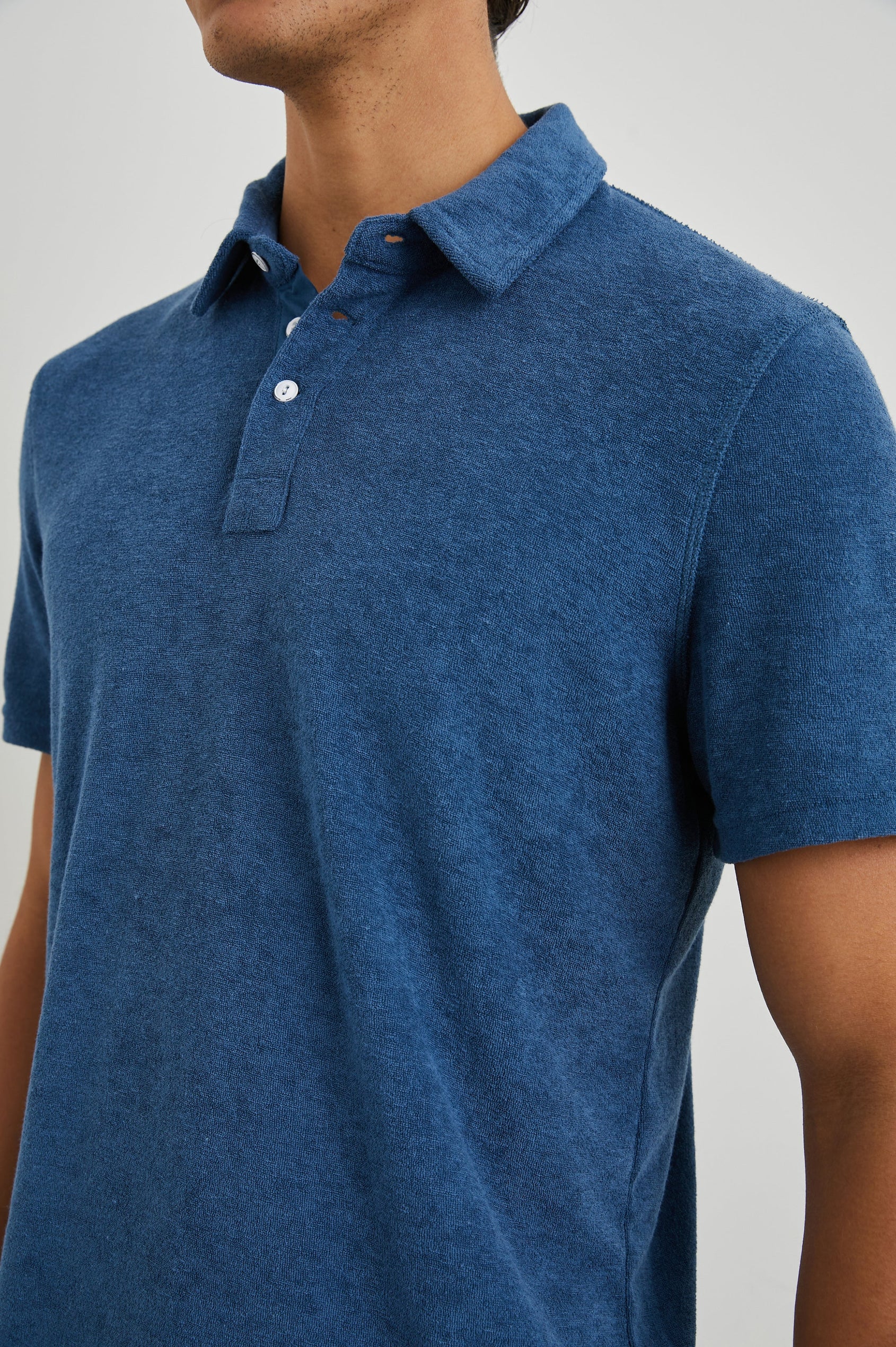 Rhen Short-Sleeve Polo Shirt with a Three-Button Placket in Ensign Blue Colorway - Front View Featured on Model