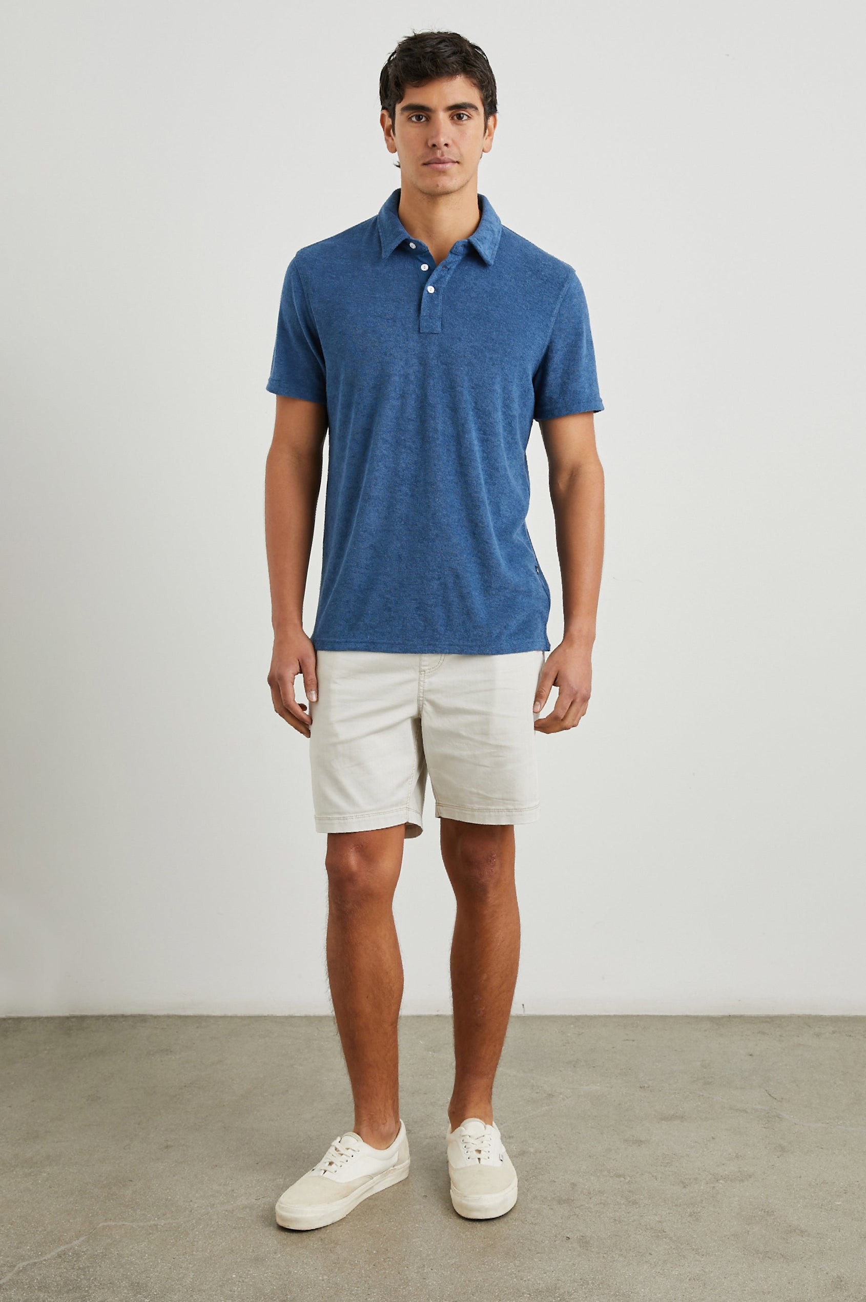 Rhen Short-Sleeve Polo Shirt with a Three-Button Placket in Ensign Blue Colorway - Front Full Body View Featured on Model