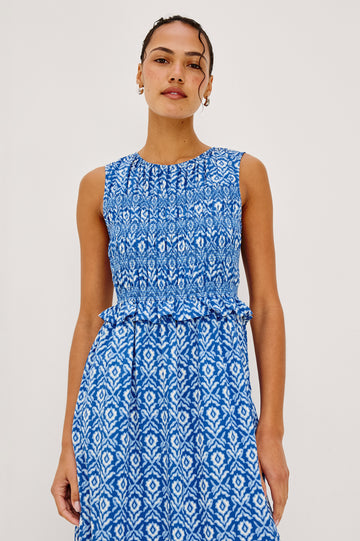 Rialto Midi Dress in Cotton Poplin With High Neckline, Smocked Bodice, Sleeveless Cut, Ruffle Trim, and Tiered Hem in Blue Ikat Colorway - Upper Body Front View Featured on Model