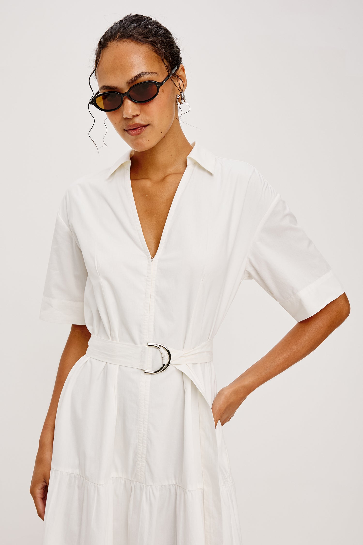 Richmond Midi Dress in Cotton With Collar Front Button Placket Side Pockets D-Ring Waist Belt Short Sleeves and Relaxed Fit in White Colorway - Upper Body Front View Featured on Model