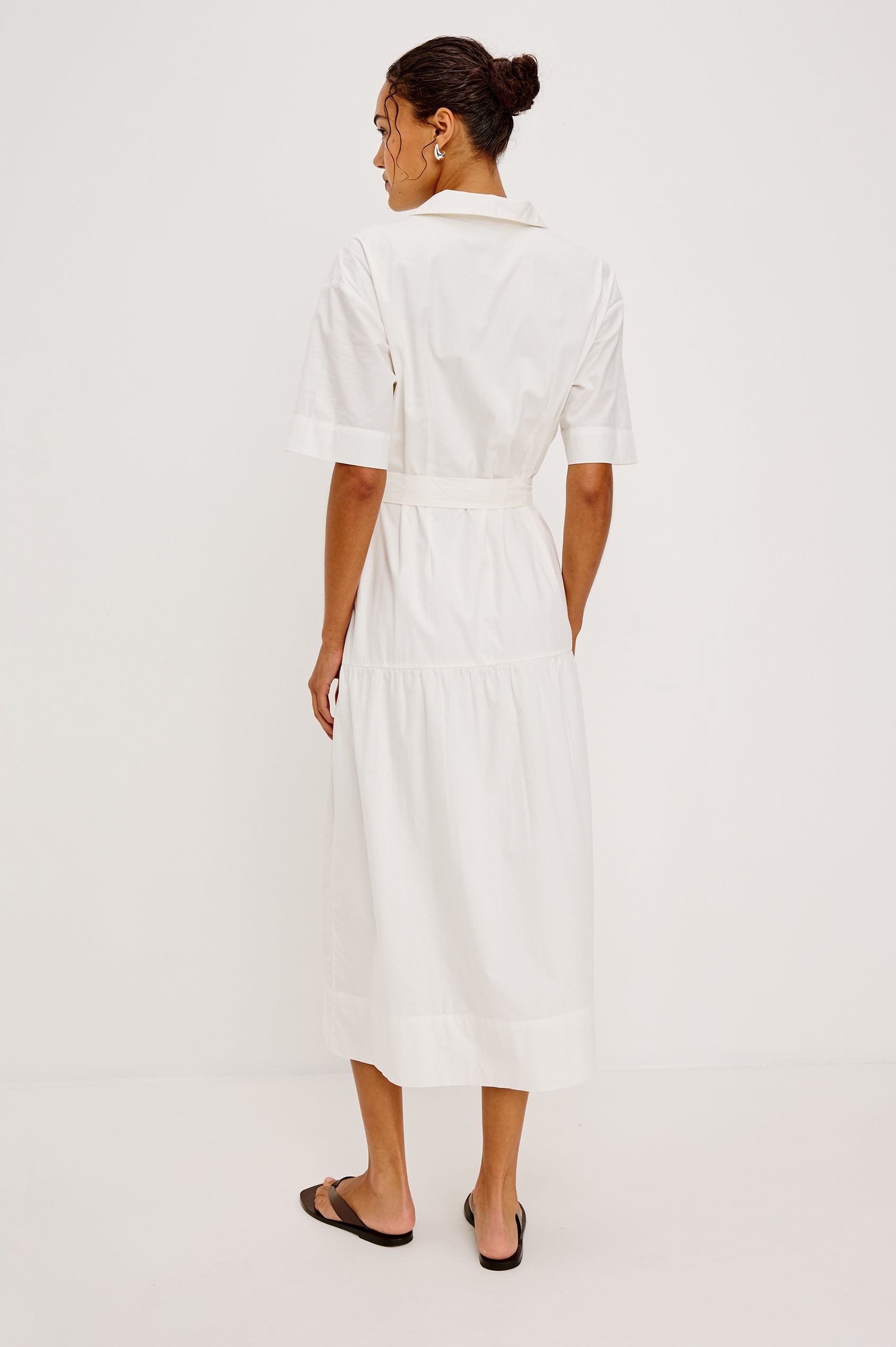 Richmond Midi Dress in Cotton With Collar Front Button Placket Side Pockets D-Ring Waist Belt Short Sleeves and Relaxed Fit in White Colorway - Full Body Back View Featured on Model