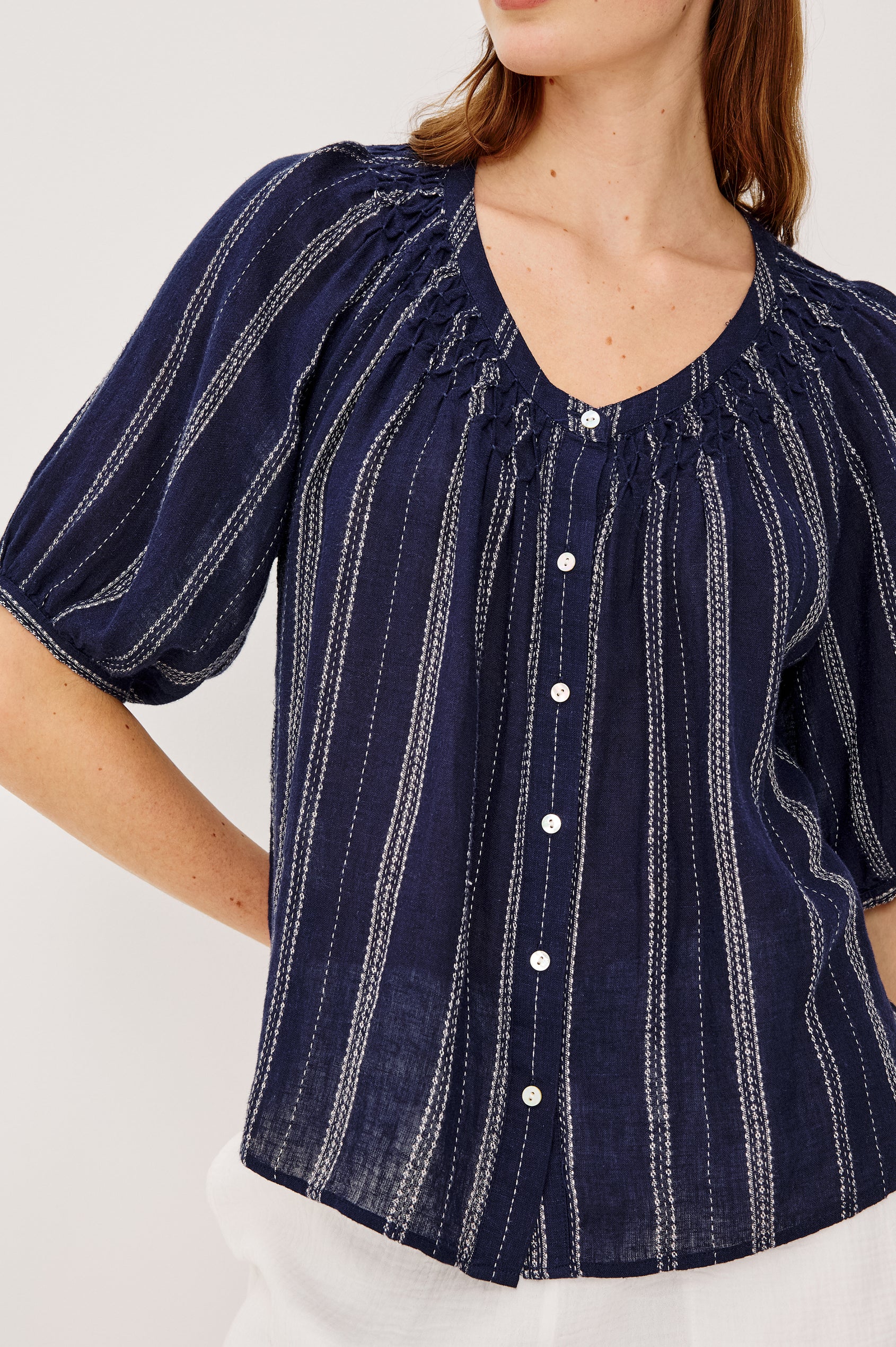 Rix Top in Linen With Scoop Neckline Relaxed Fit Smocked Yoke Elbow-Length Raglan Sleeves and Front Buttons in Marina Stripe Colorway - Upper Body Front View Featured on Model
