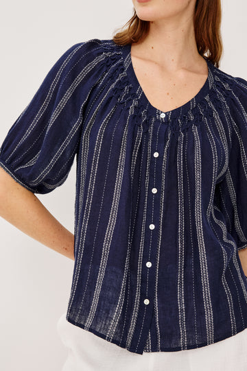 Rix Top in Linen With Scoop Neckline Relaxed Fit Smocked Yoke Elbow-Length Raglan Sleeves and Front Buttons in Marina Stripe Colorway - Upper Body Front View Featured on Model