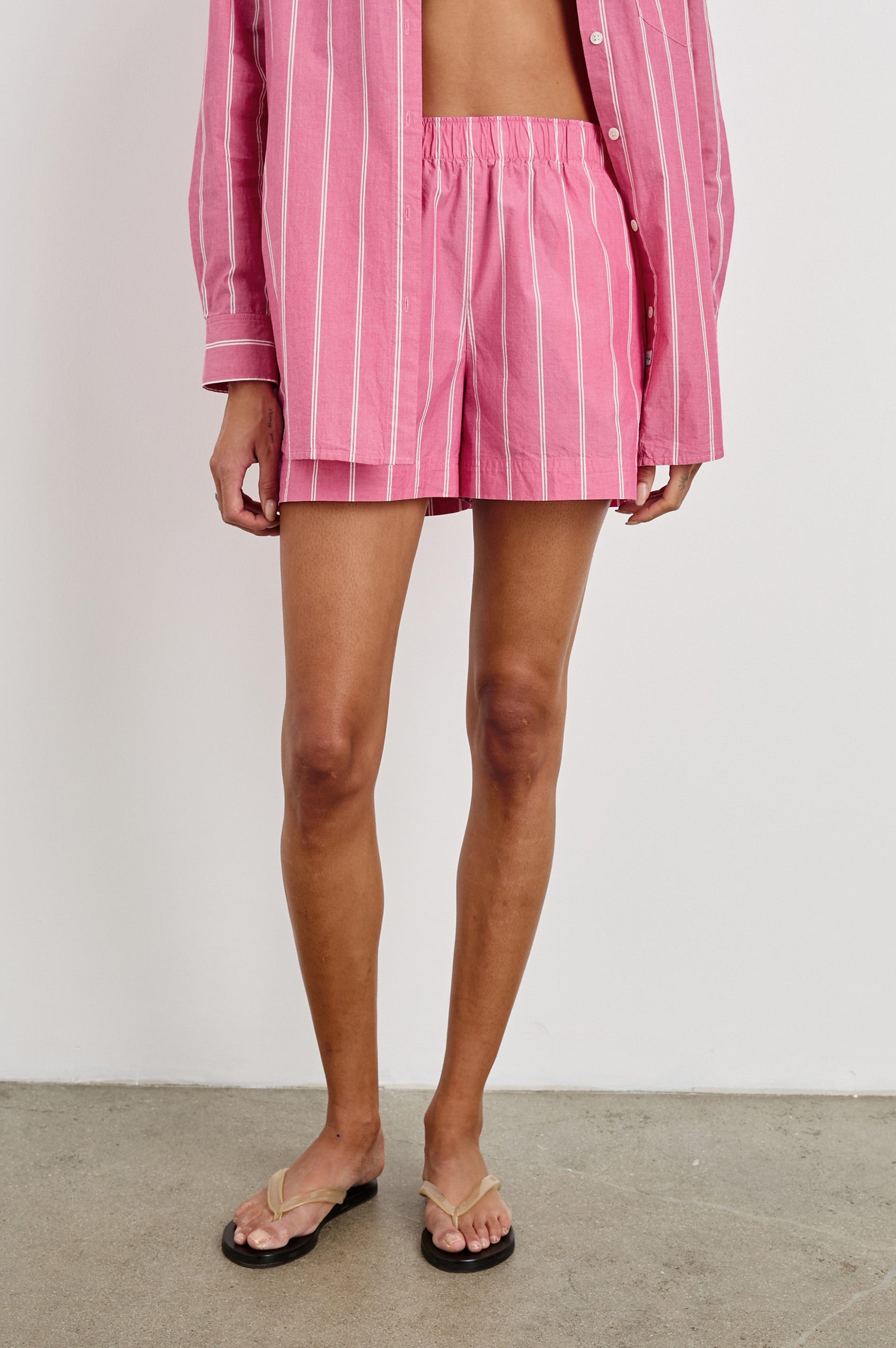 Rocky mid rise, loose fitting cotton short with elastic waistband in Hibiscus White Stripe colorway - front view on model with matching shirt