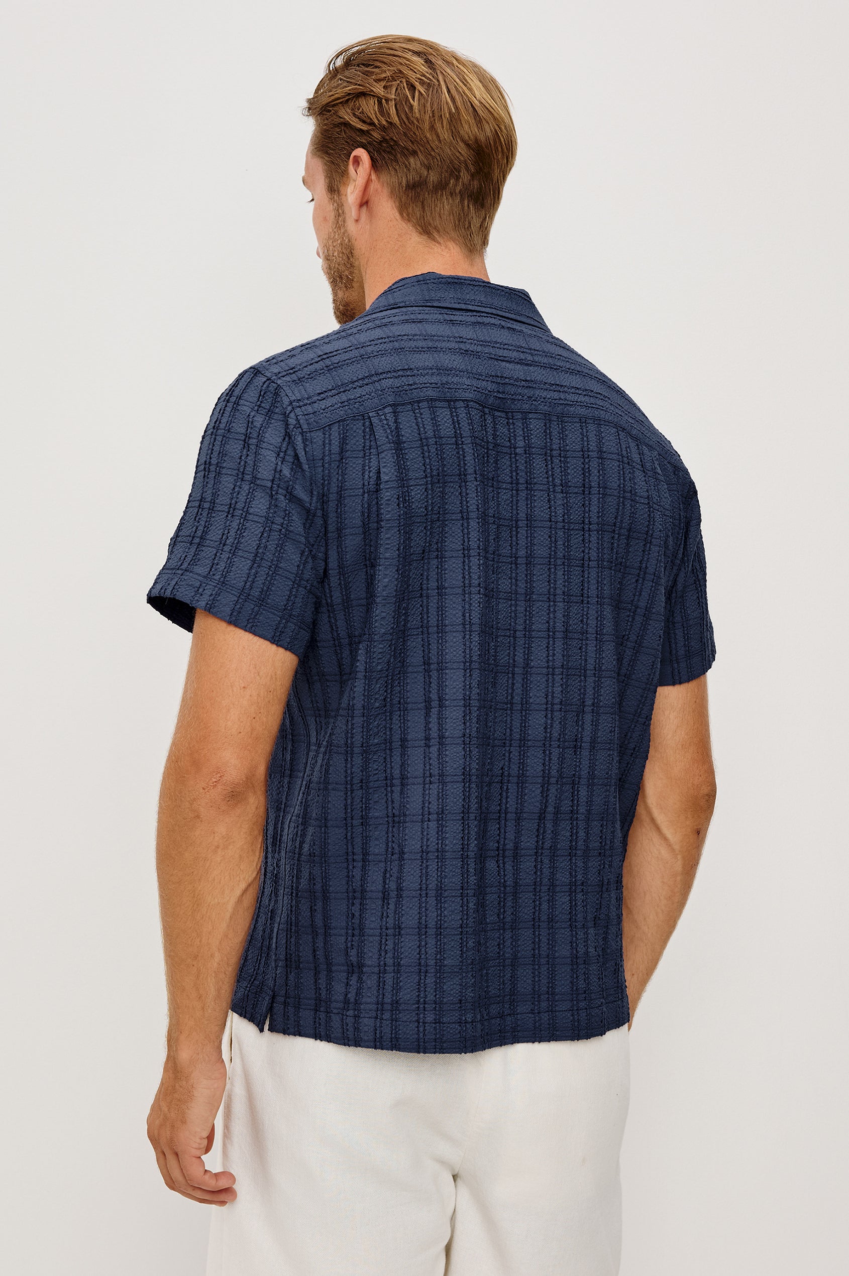 Rook Button-Up Shirt With Crosshatch Texture, Notched Collar, Short Sleeves, and Slightly Boxy Fit in Navy Colorway - Upper Body Back View Featured on Model
