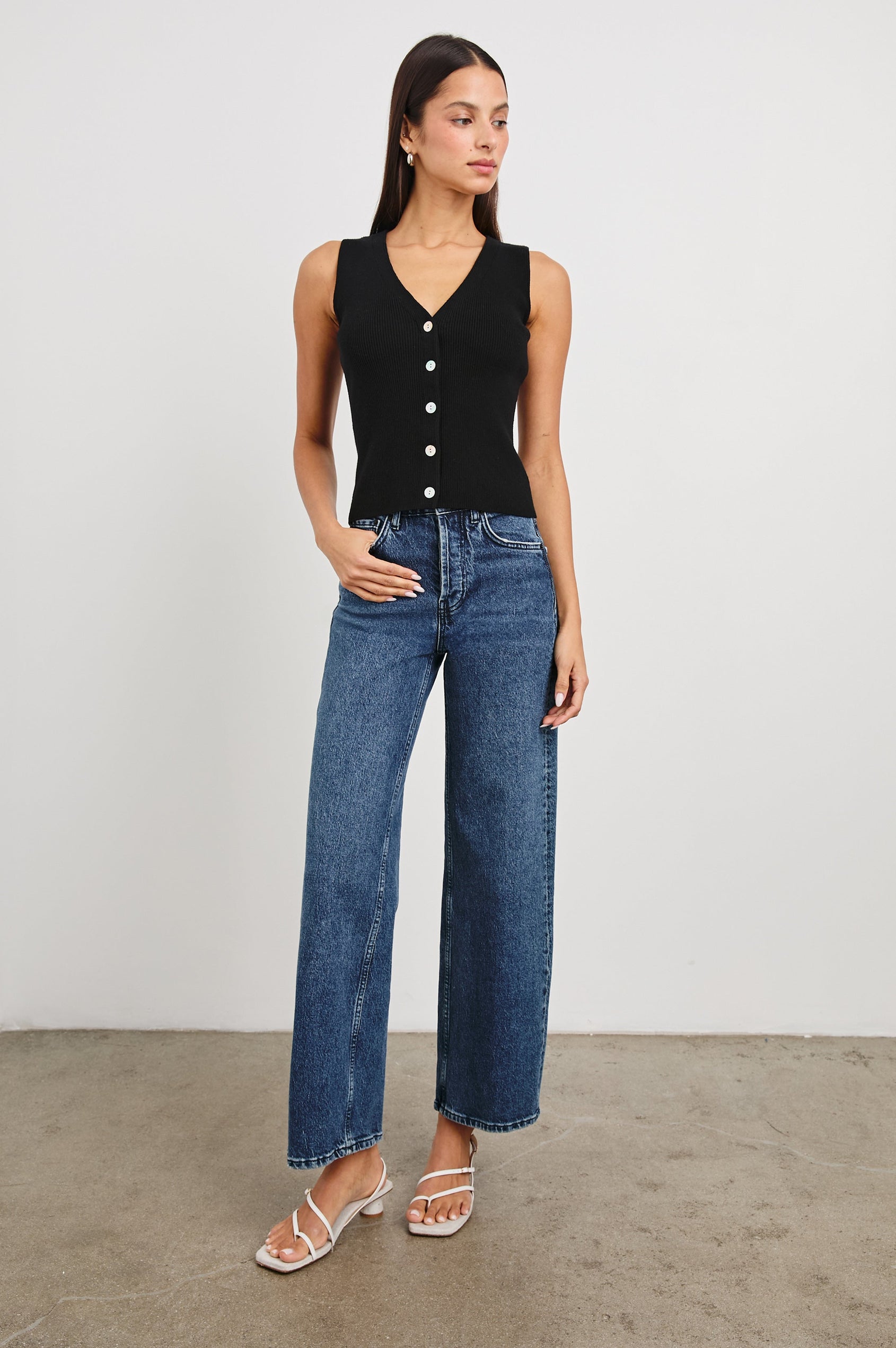 Rosa Ribbed Sleeveless Vest with a V Neckline and Buttons Down the Front in Black Colorway - Front Full Body View Featured on Model